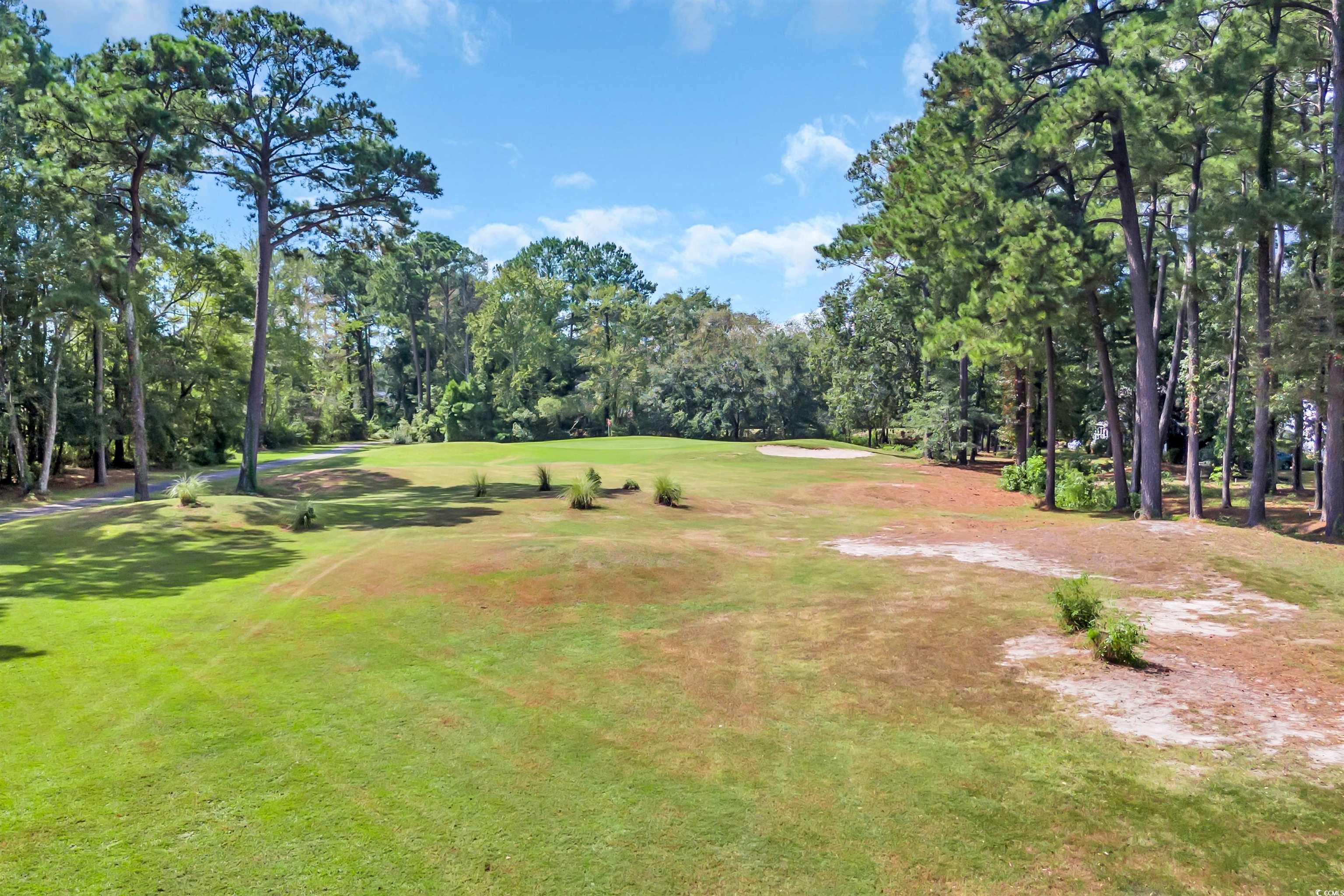 9350 Pinckney Lane Murrells Inlet, SC 29576 - Photo 35 of 40 Surrounding community featuring view of wooded area, a lawn, and view of golf course