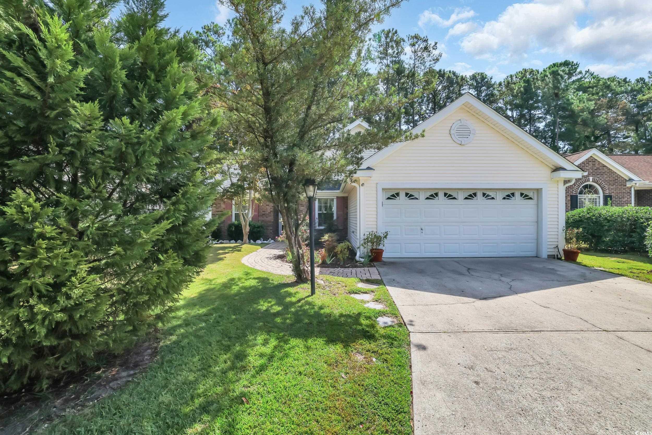 9350 Pinckney Lane Murrells Inlet, SC 29576 - Photo 36 of 40 Single story home with driveway, a front lawn, and an attached garage