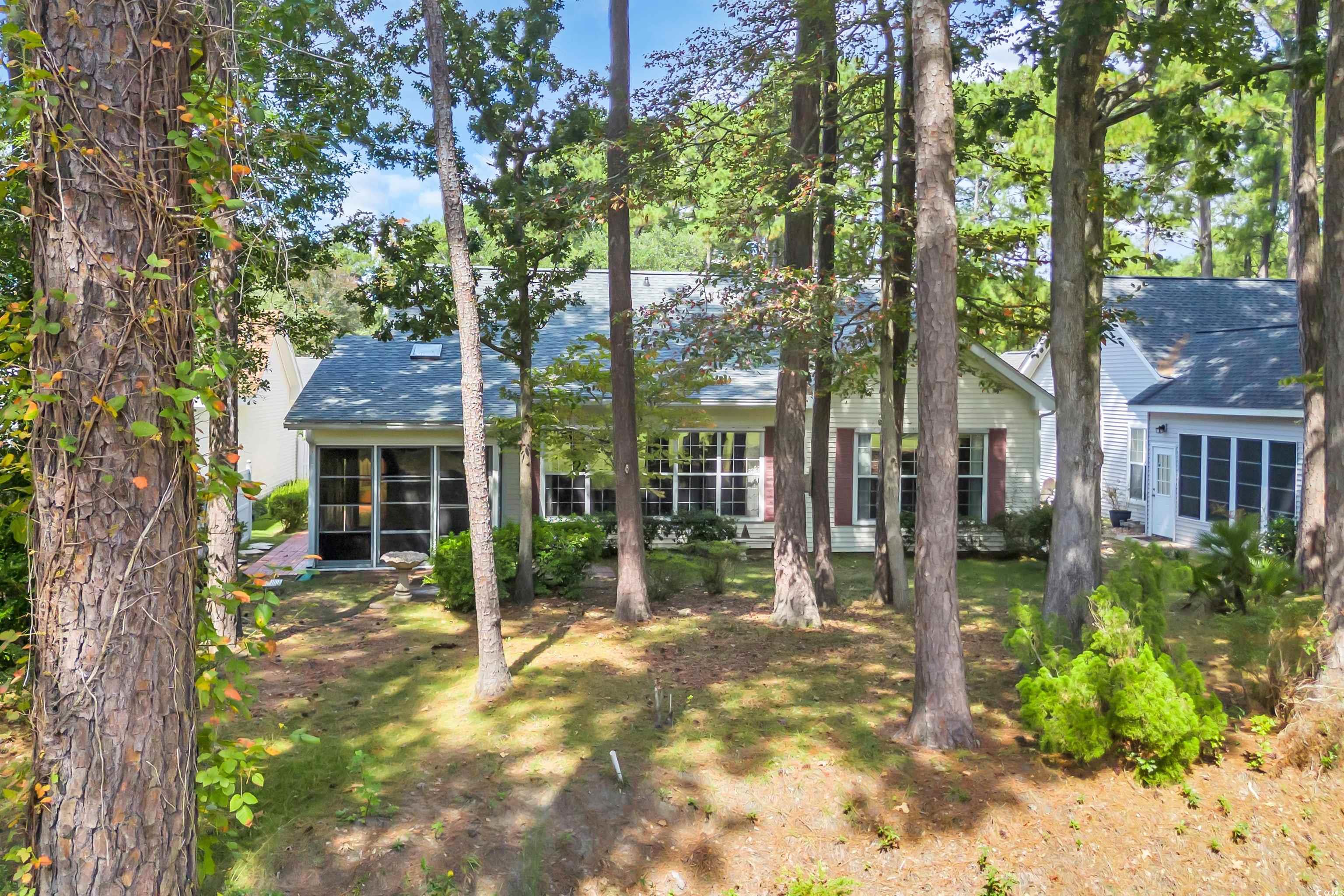 9350 Pinckney Lane Murrells Inlet, SC 29576 - Photo 8 of 40 View of front facade with a sunroom and a shingled roof