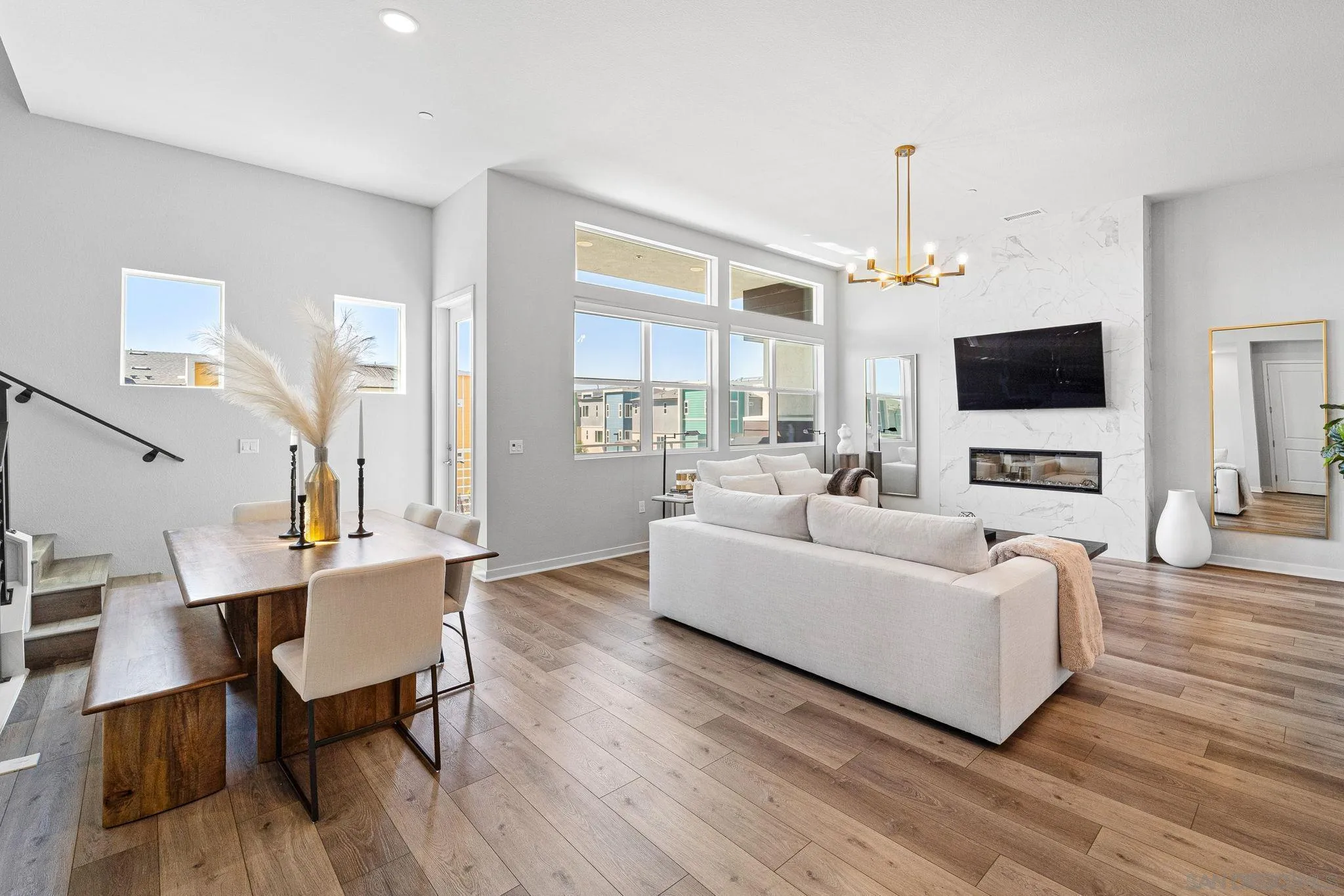 a living room with furniture a fireplace and a flat screen tv
