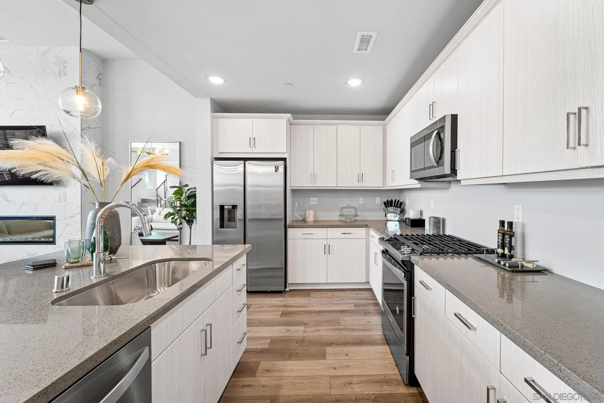 3002 Bravo Loop, Unit 4 Chula Vista, CA 91915 - Photo 16 of 38 a kitchen with a sink stove and refrigerator