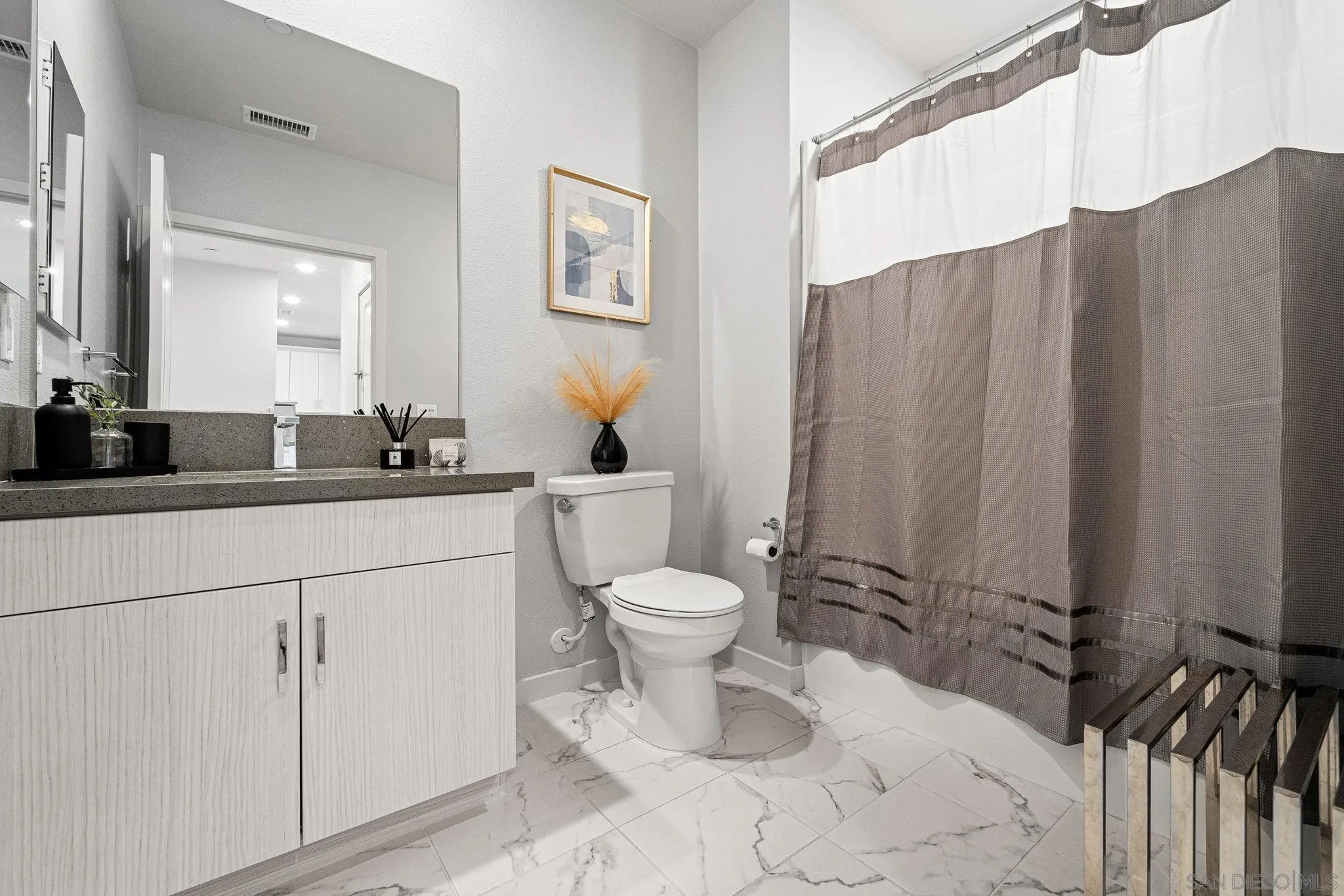 3002 Bravo Loop, Unit 4 Chula Vista, CA 91915 - Photo 23 of 38 a bathroom with a toilet a sink and a mirror