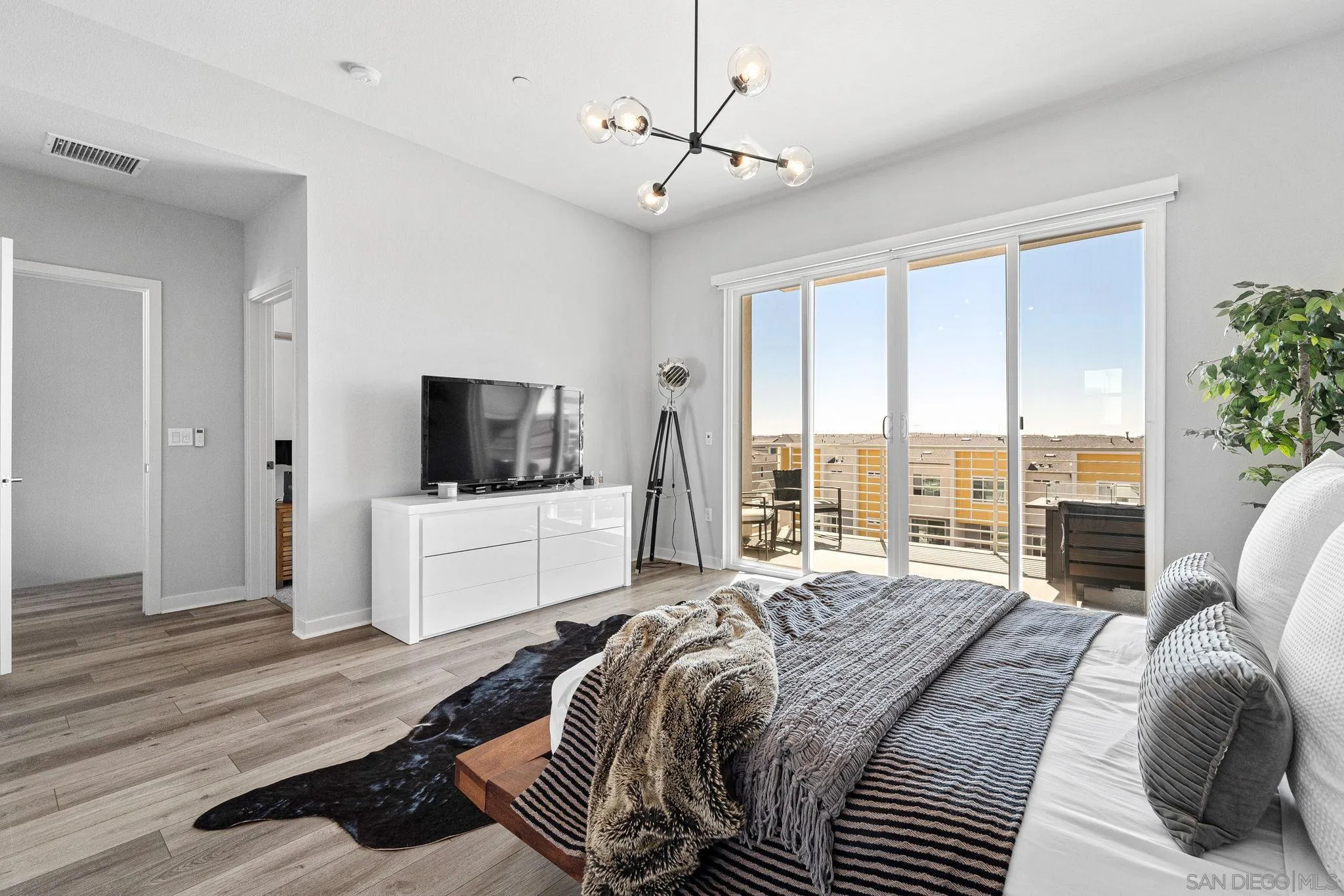 3002 Bravo Loop, Unit 4 Chula Vista, CA 91915 - Photo 25 of 38 a bedroom with a large bed and a flat screen tv