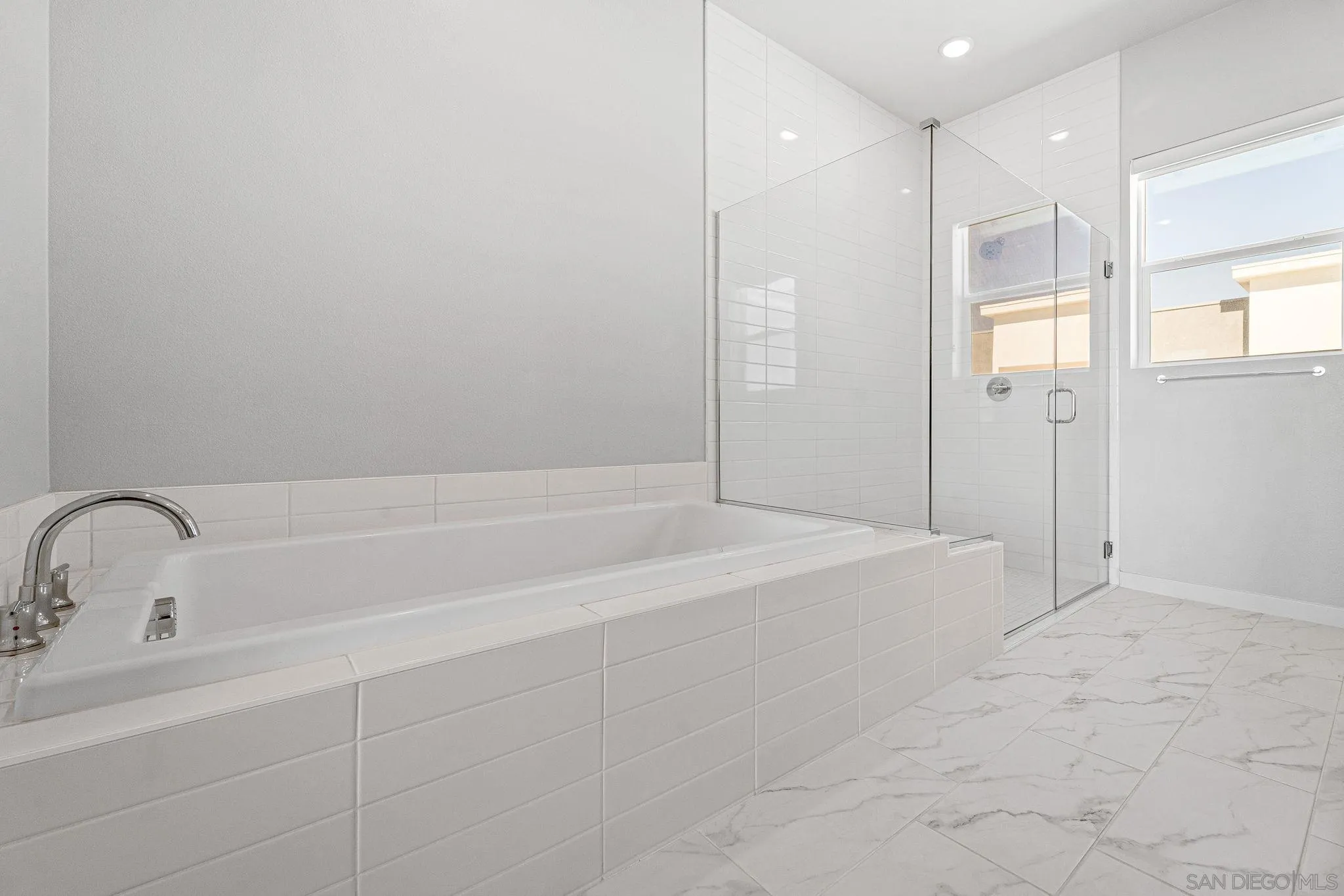 3002 Bravo Loop, Unit 4 Chula Vista, CA 91915 - Photo 28 of 38 a bathroom with a bathtub and a shower