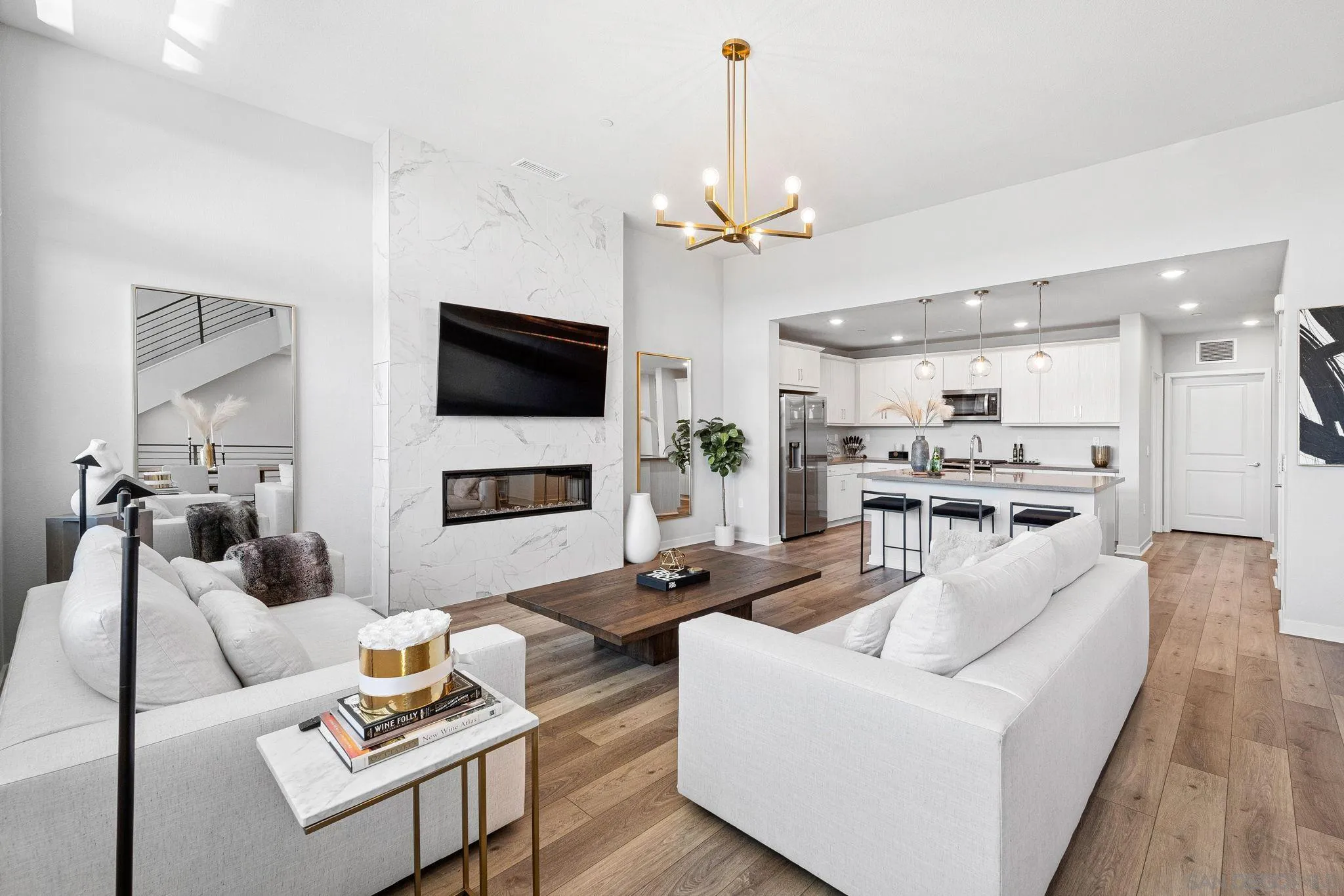 3002 Bravo Loop, Unit 4 Chula Vista, CA 91915 - Photo 5 of 38 a living room with furniture a flat screen tv and kitchen view
