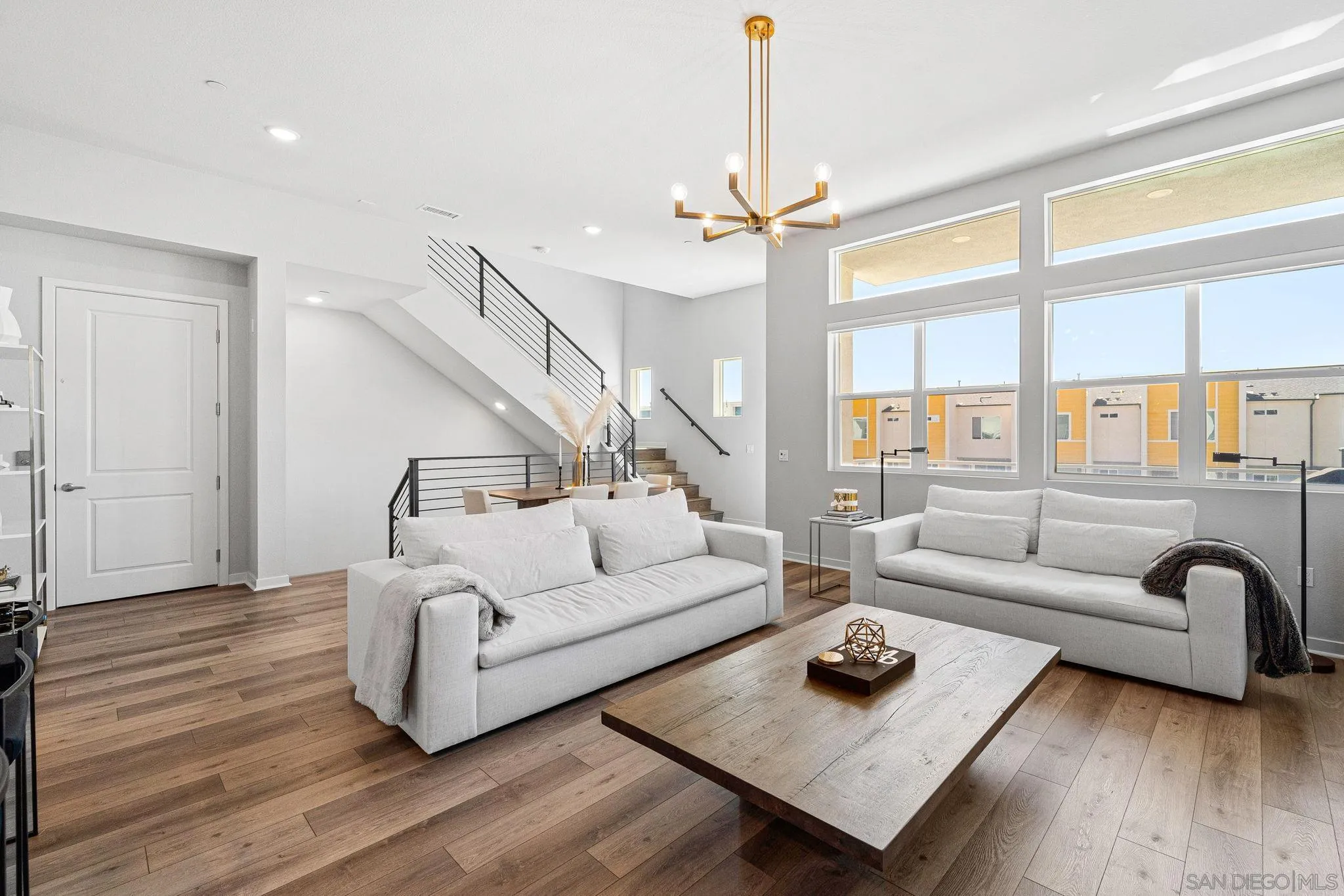 3002 Bravo Loop, Unit 4 Chula Vista, CA 91915 - Photo 6 of 38 a living room with furniture and a chandelier