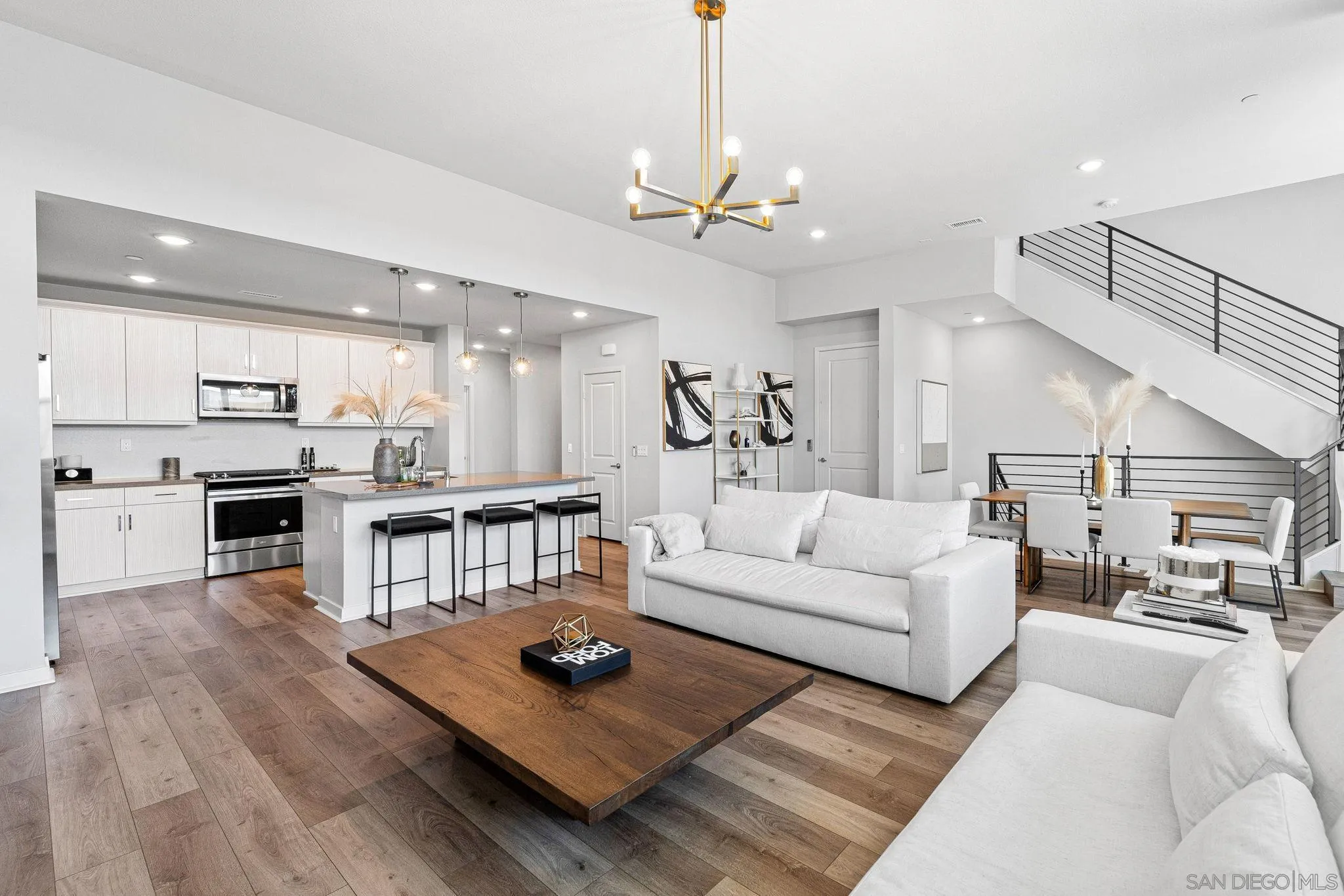 3002 Bravo Loop, Unit 4 Chula Vista, CA 91915 - Photo 7 of 38 a living room with furniture kitchen view and a wooden floor