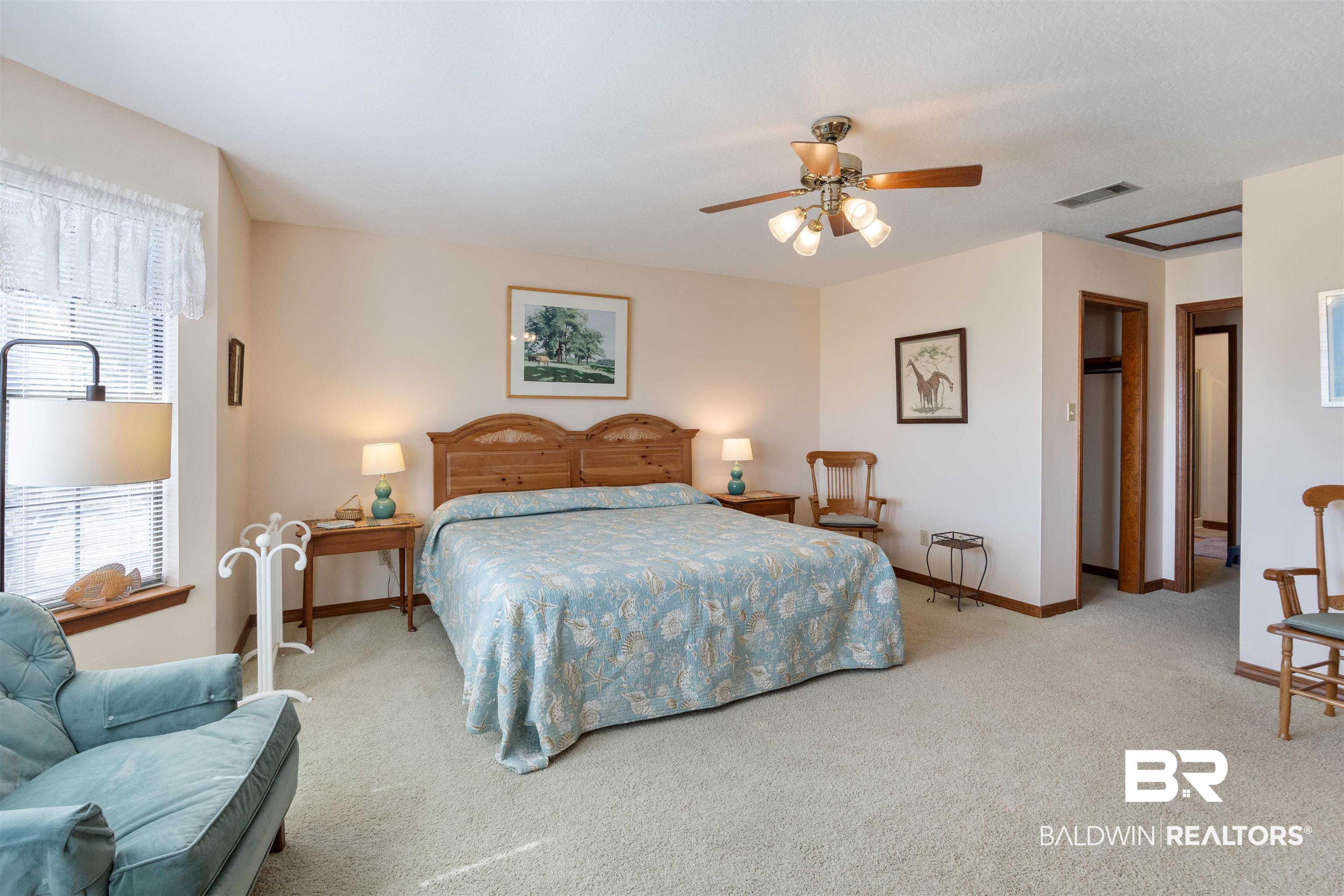 27321 Marina Road Orange Beach, AL 36561 - Photo 27 of 55 Carpeted bedroom featuring ceiling fan