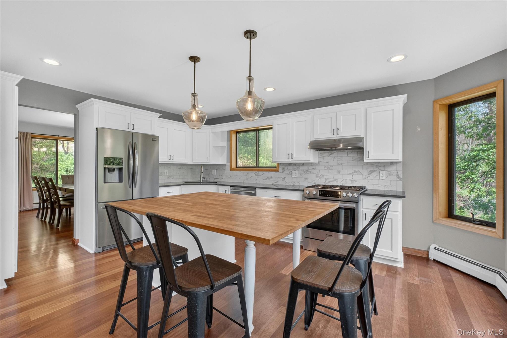 85 Ward Road Salt Point, NY 12578 - Photo 11 of 49 a kitchen with stainless steel appliances granite countertop a dining table chairs refrigerator and sink