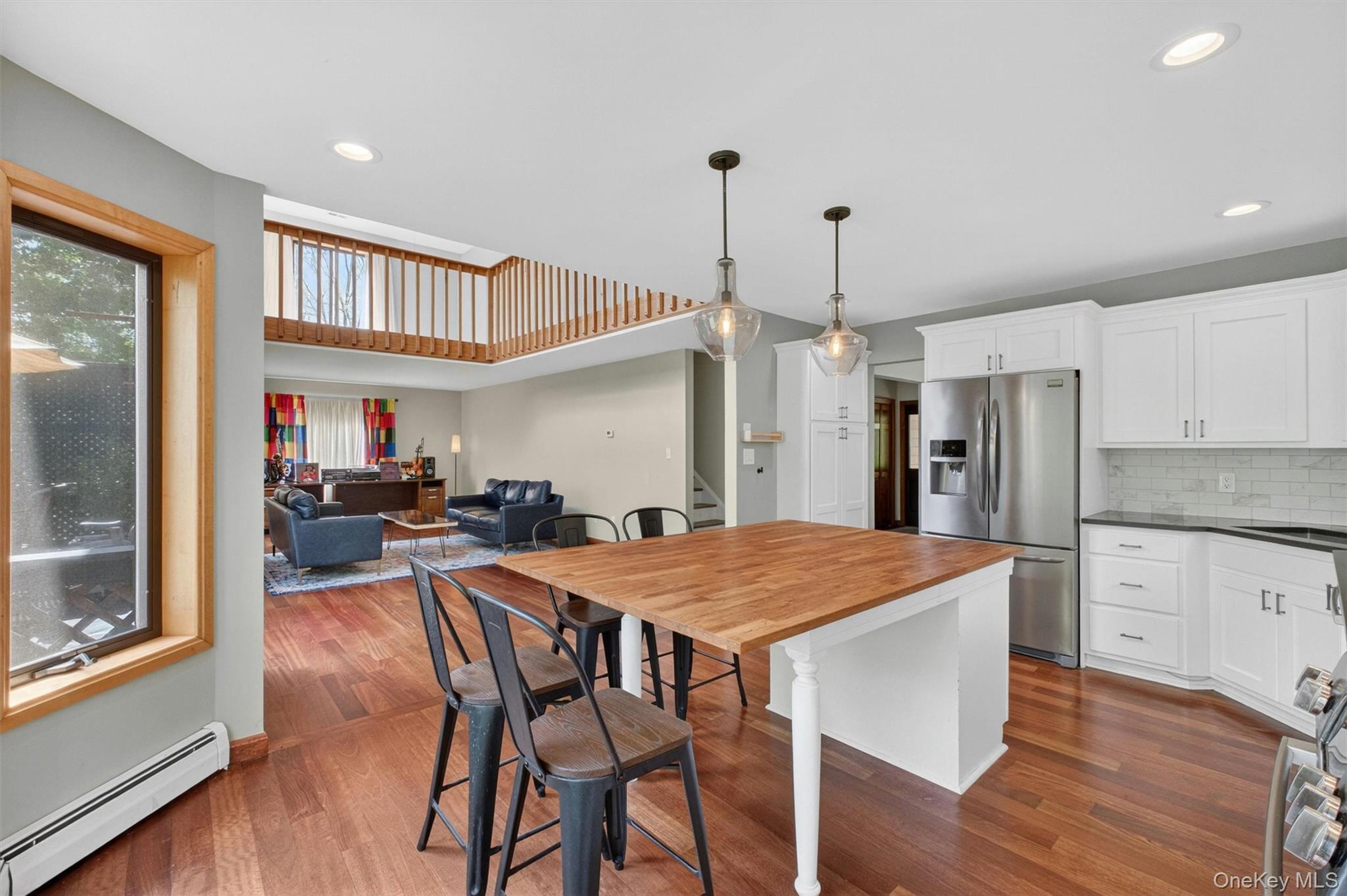 85 Ward Road Salt Point, NY 12578 - Photo 12 of 49 a kitchen with stainless steel appliances granite countertop a kitchen island a stove a refrigerator a sink dishwasher a dining table and chairs with wooden floor