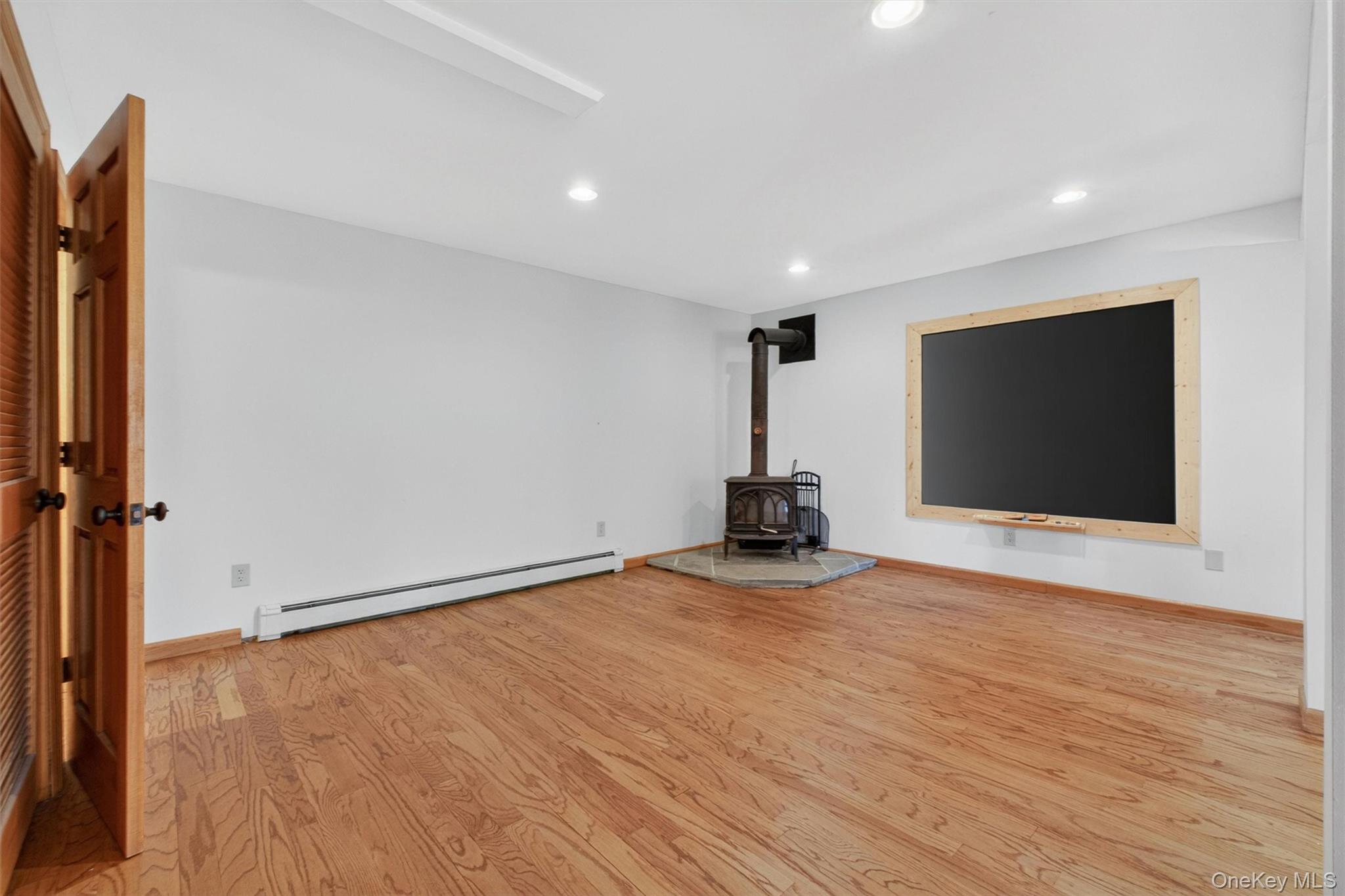 85 Ward Road Salt Point, NY 12578 - Photo 36 of 49 a view of an empty room with wooden floor and a flat screen tv