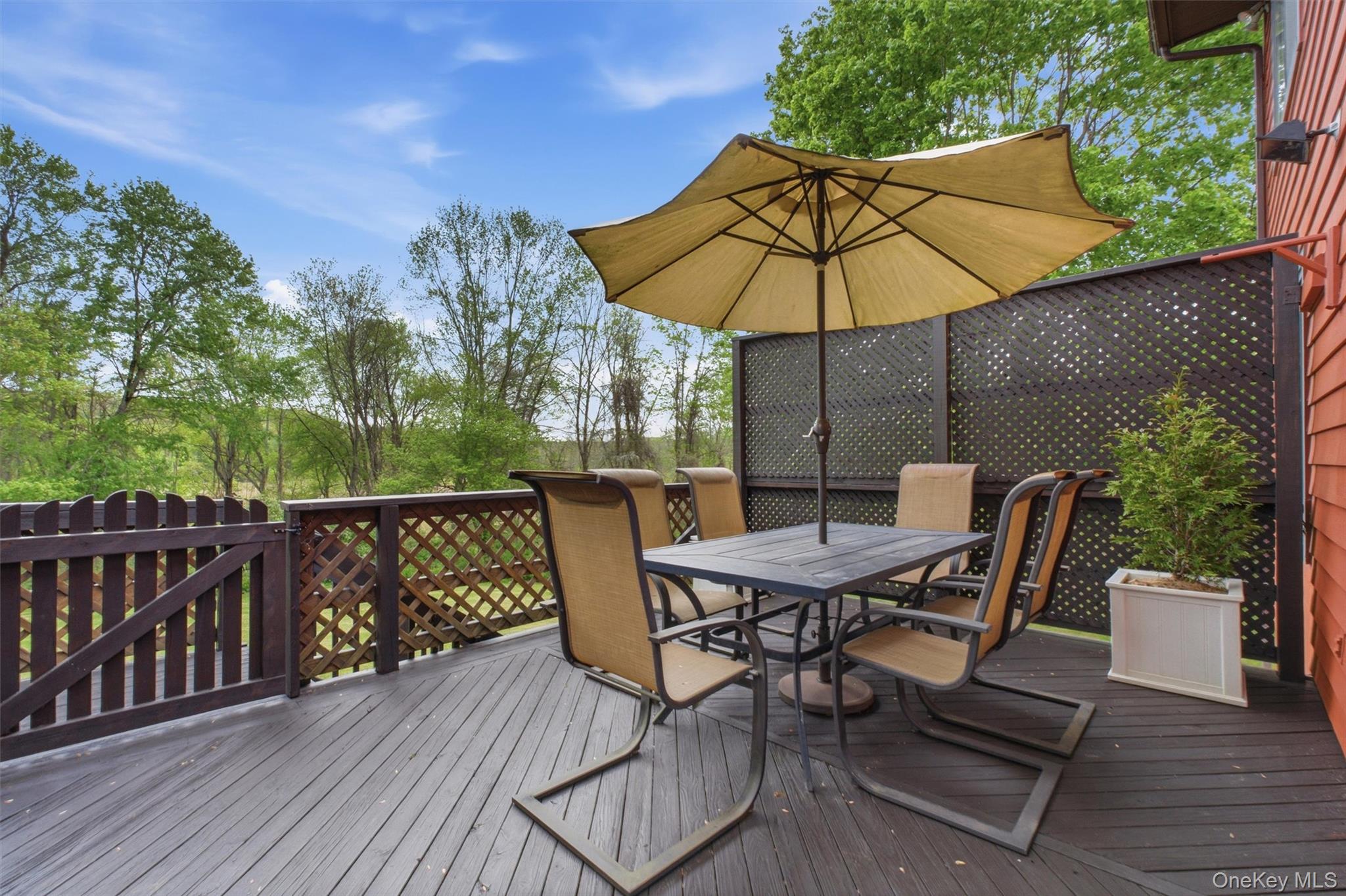 85 Ward Road Salt Point, NY 12578 - Photo 40 of 49 a patio with wooden floor a yard a table and chairs
