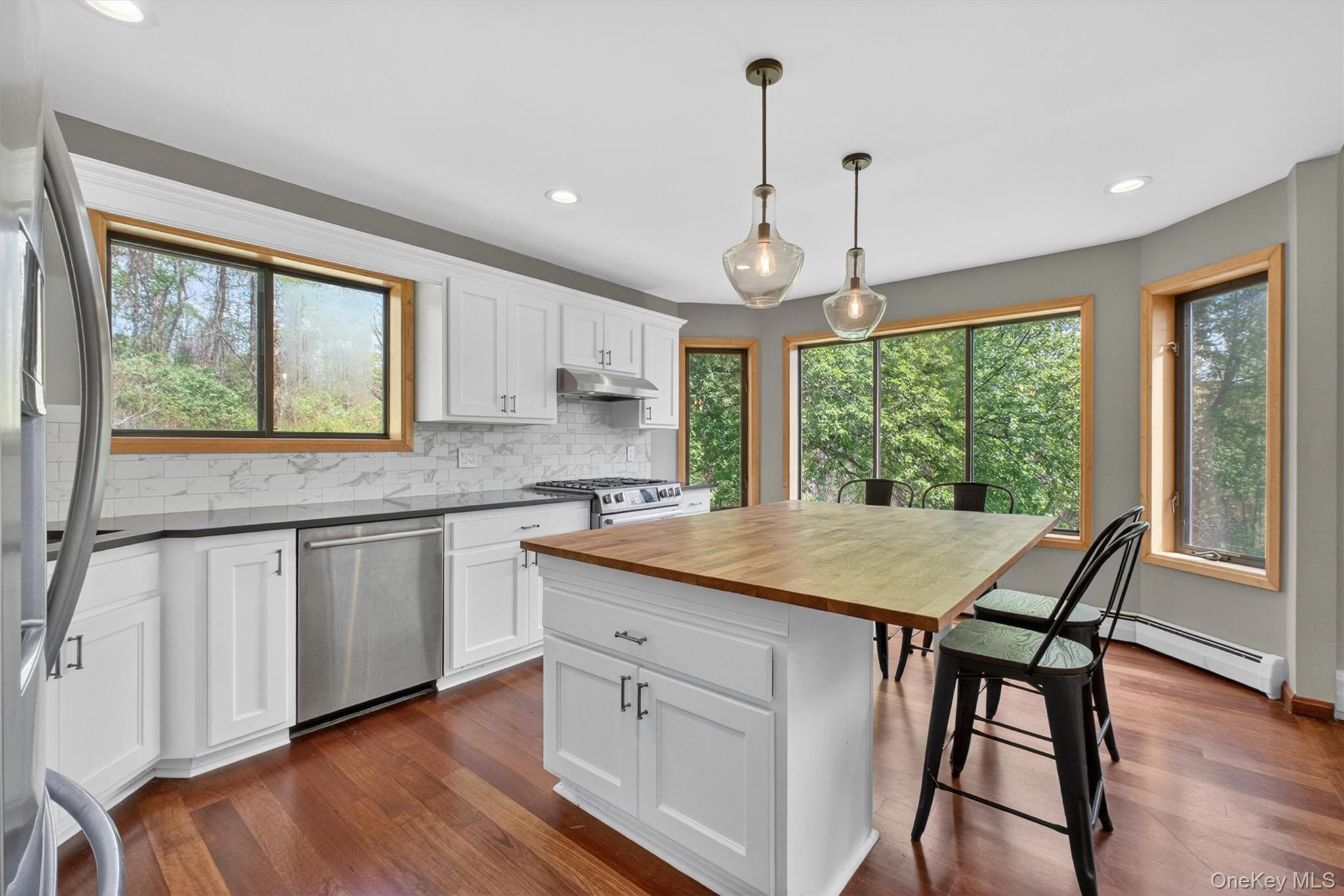 85 Ward Road Salt Point, NY 12578 - Photo 9 of 49 a kitchen with a stove a sink a window and wooden floor