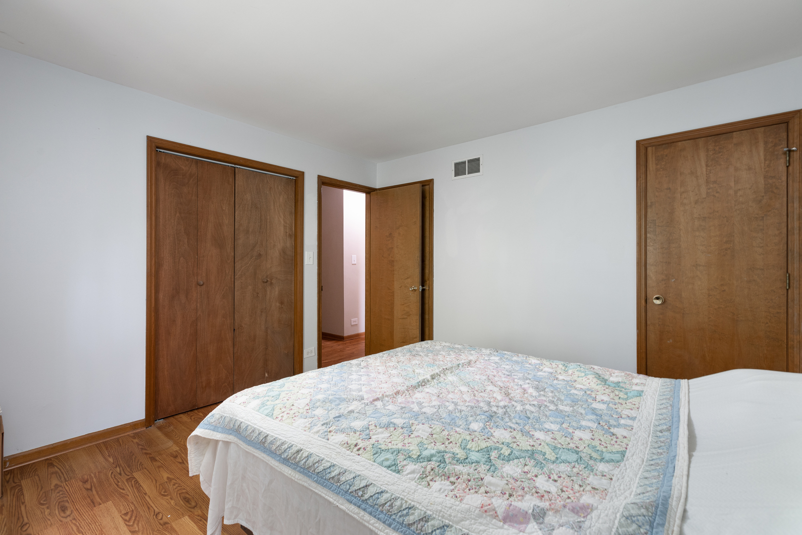 5740 Wolf Road Western Springs, IL 60558 - Photo 14 of 26 a bedroom with a bed and wooden floor