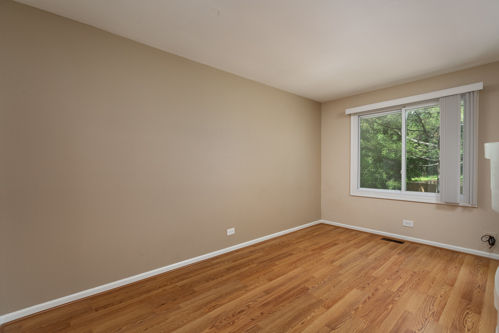 5740 Wolf Road Western Springs, IL 60558 - Photo 15 of 26 an empty room with wooden floor and windows