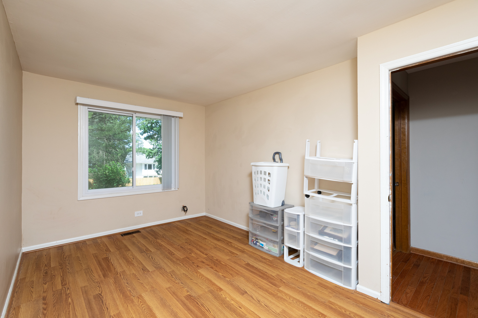 5740 Wolf Road Western Springs, IL 60558 - Photo 16 of 26 an empty room with wooden floor and windows