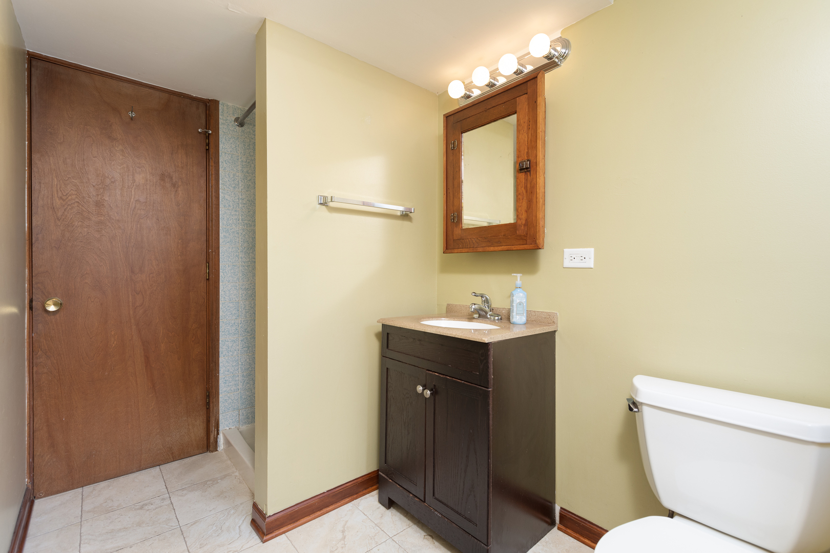 5740 Wolf Road Western Springs, IL 60558 - Photo 20 of 26 a bathroom with a toilet sink and mirror