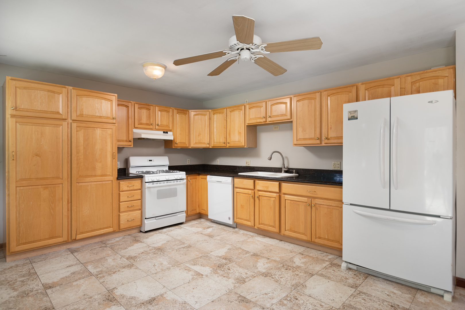 5740 Wolf Road Western Springs, IL 60558 - Photo 5 of 26 a kitchen with white cabinets and white appliances