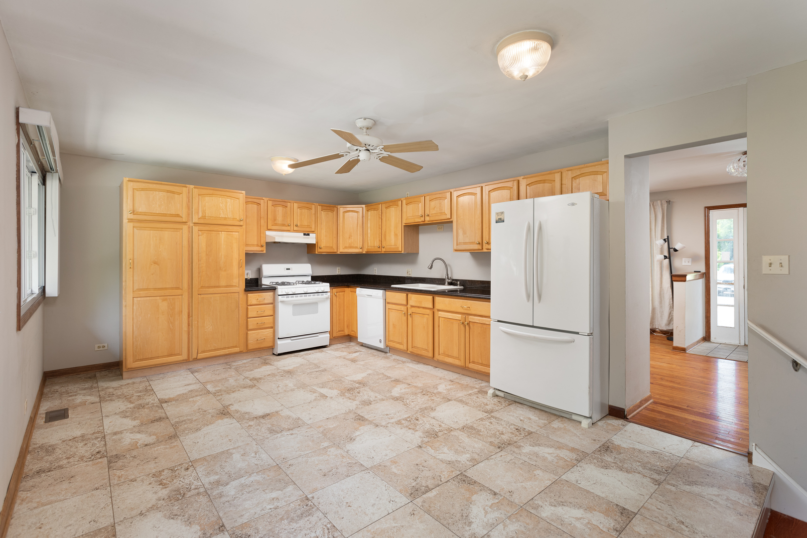 5740 Wolf Road Western Springs, IL 60558 - Photo 6 of 26 a kitchen with white cabinets and stainless steel appliances