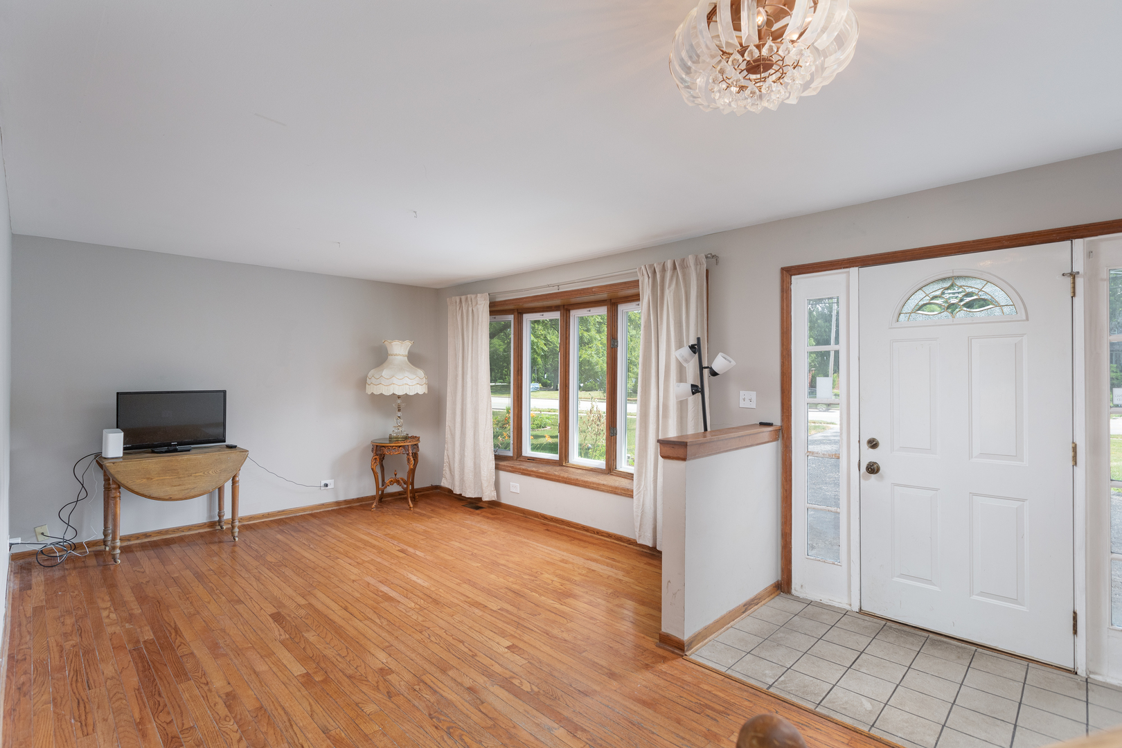 5740 Wolf Road Western Springs, IL 60558 - Photo 9 of 26 a view of an empty room with a window and wooden floor
