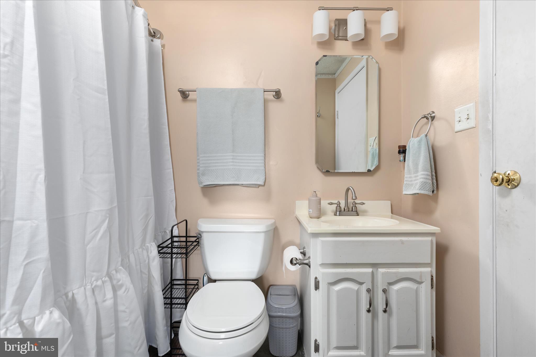 8307 Crestmont Circle Springfield, VA 22153 - Photo 13 of 33 a bathroom with a toilet sink and mirror