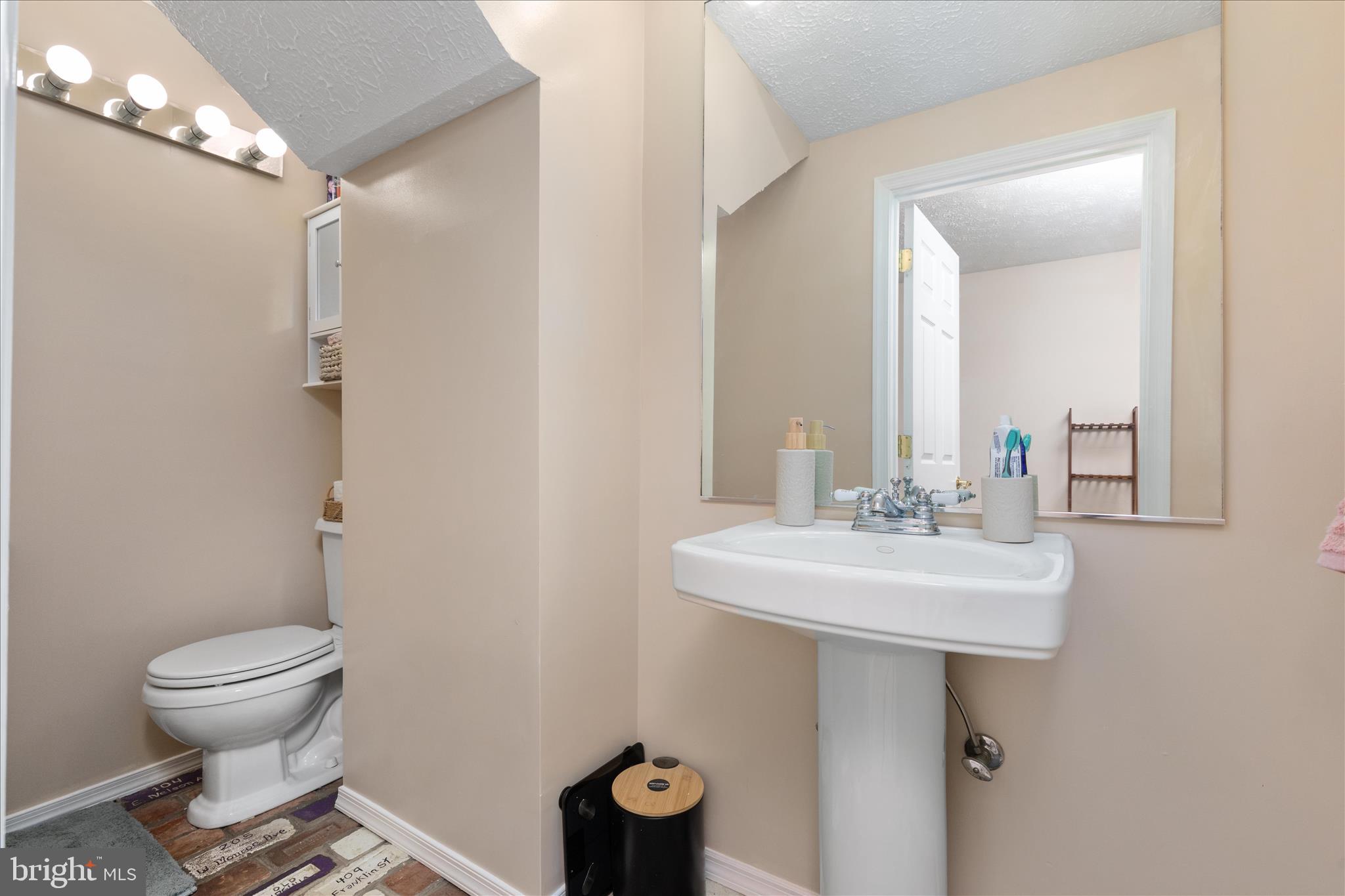 8307 Crestmont Circle Springfield, VA 22153 - Photo 20 of 33 a bathroom with a sink toilet and mirror