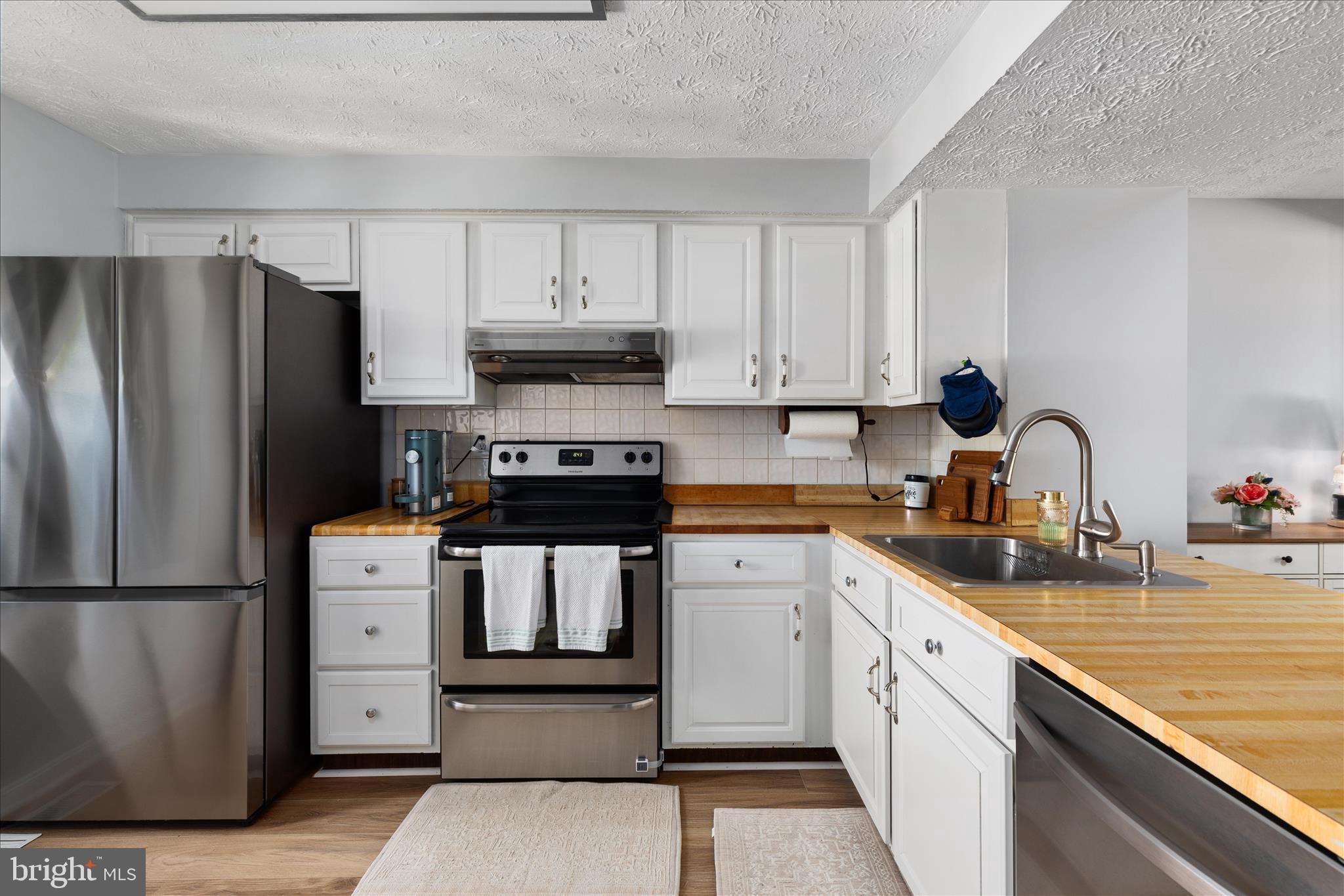 8307 Crestmont Circle Springfield, VA 22153 - Photo 5 of 33 a kitchen with a refrigerator sink and cabinets