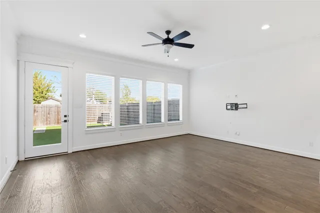 wooden floor in an empty room with a window