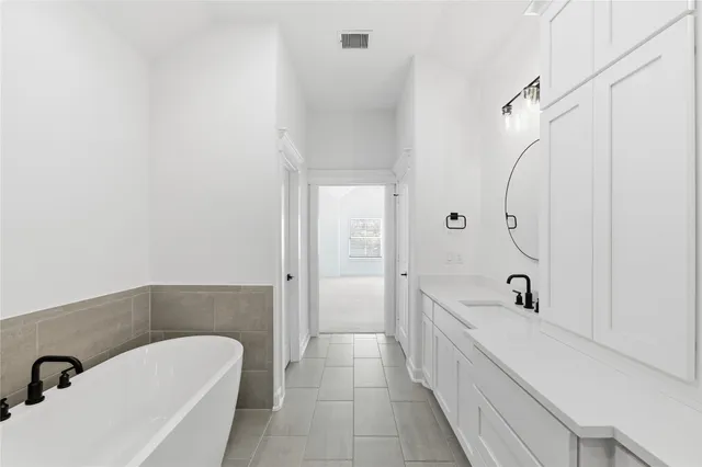 a bathroom with a shower and a sink