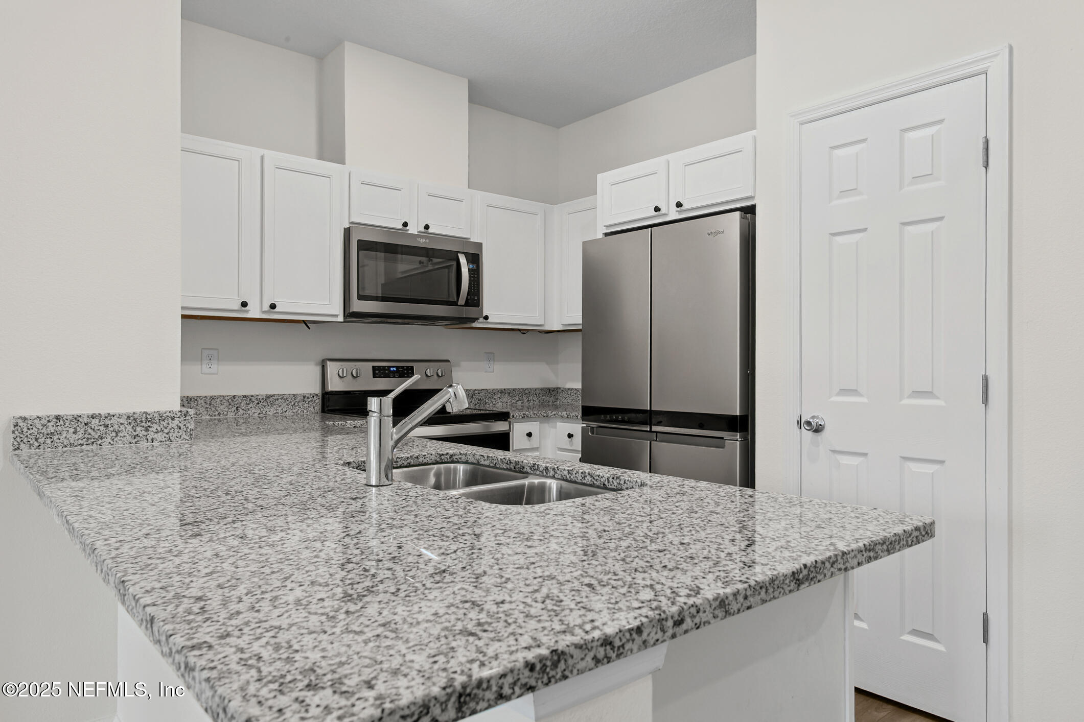 7690 Merchants Way Jacksonville, FL 32222 - Photo 11 of 52 a kitchen with stainless steel appliances granite countertop a sink stove and microwave