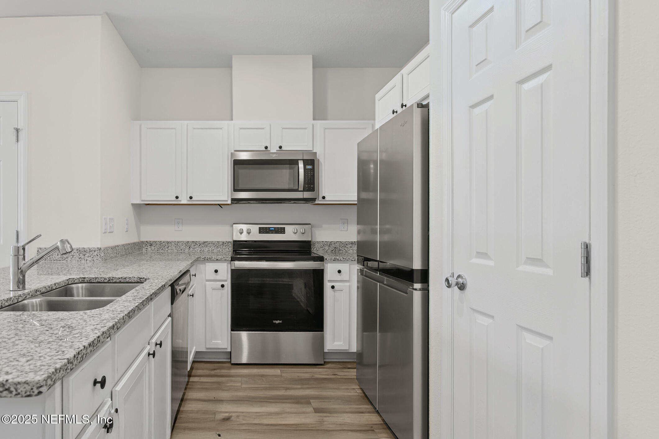 7690 Merchants Way Jacksonville, FL 32222 - Photo 12 of 52 a kitchen with granite countertop a refrigerator stove and sink