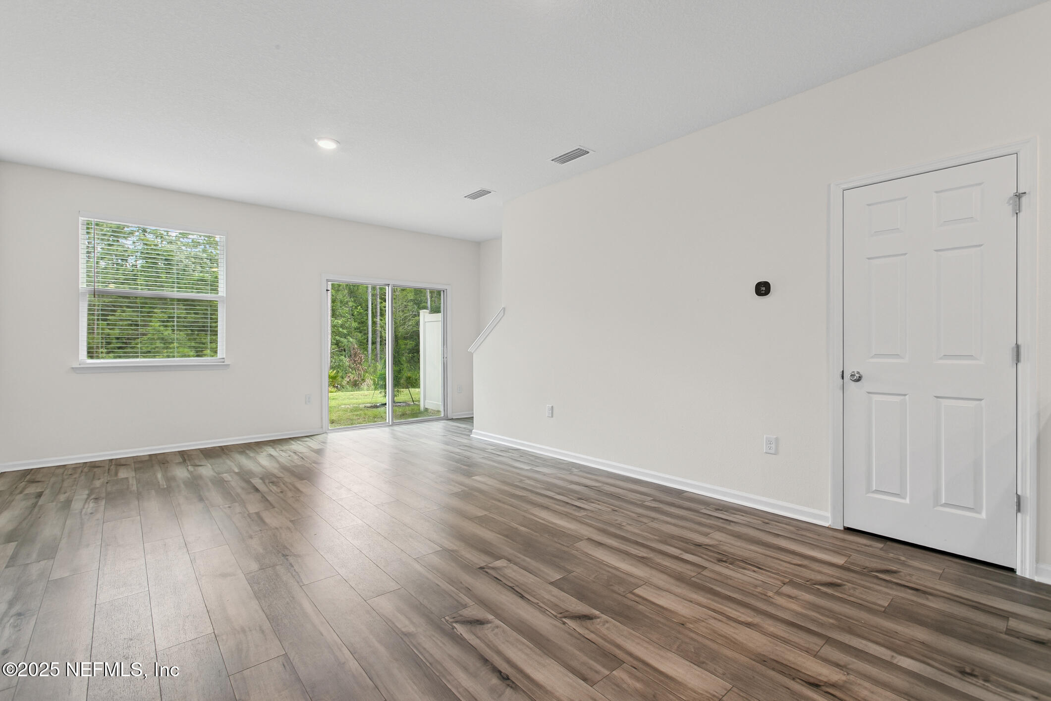 7690 Merchants Way Jacksonville, FL 32222 - Photo 17 of 52 a view of an empty room with wooden floor and a window