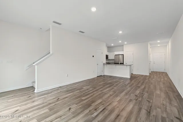 a view of kitchen and hall with wooden floor
