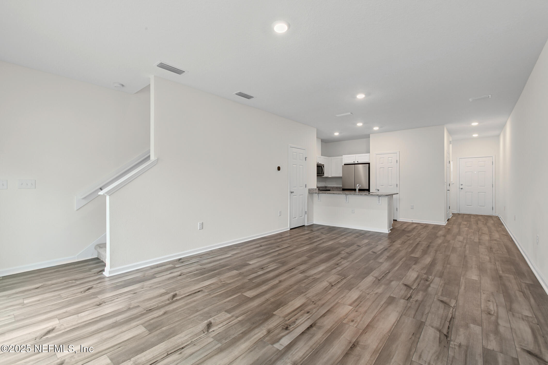 7690 Merchants Way Jacksonville, FL 32222 - Photo 18 of 52 a view of kitchen and hall with wooden floor
