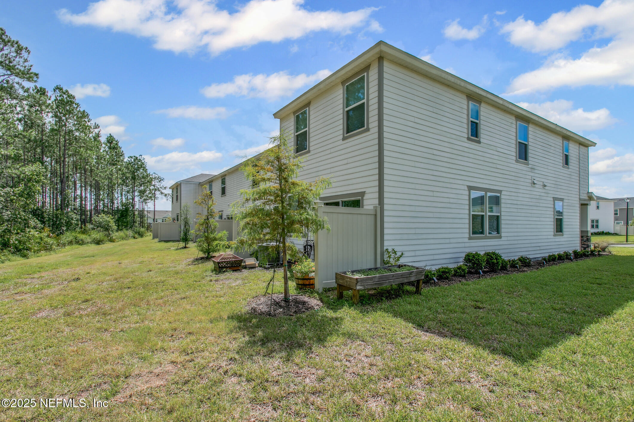 7690 Merchants Way Jacksonville, FL 32222 - Photo 37 of 52 a view of a house with backyard and trees