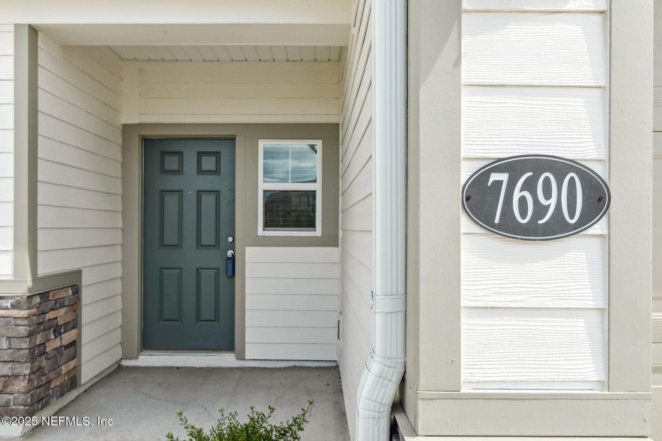 7690 Merchants Way Jacksonville, FL 32222 - Photo 4 of 52 a view of a door and a window of the house