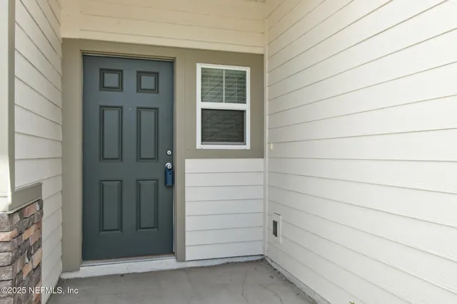 a view of a door and a window
