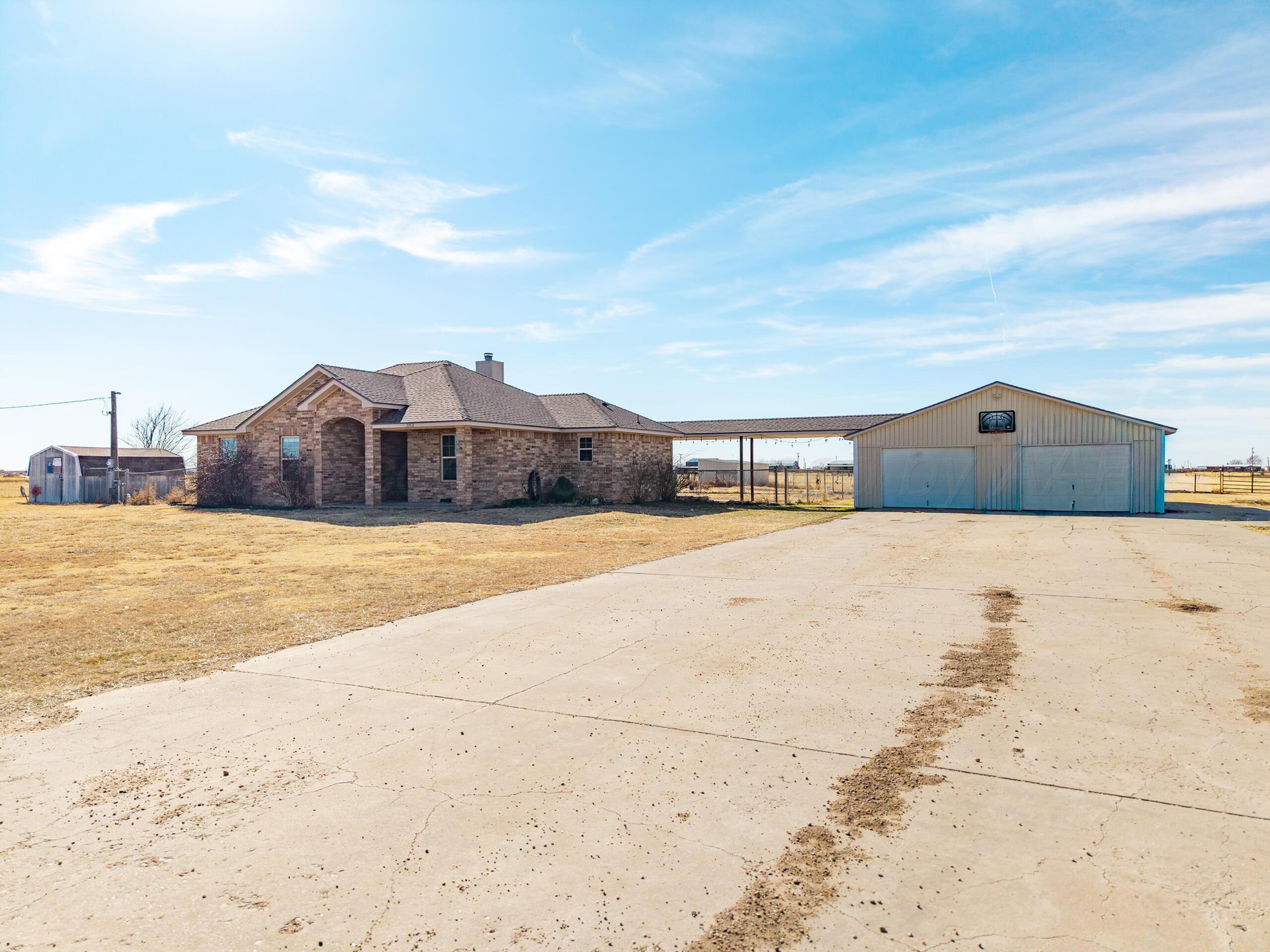 383 County Road 309 Panhandle, TX 79068 - Photo 1 of 35 a front view of a house with a yard