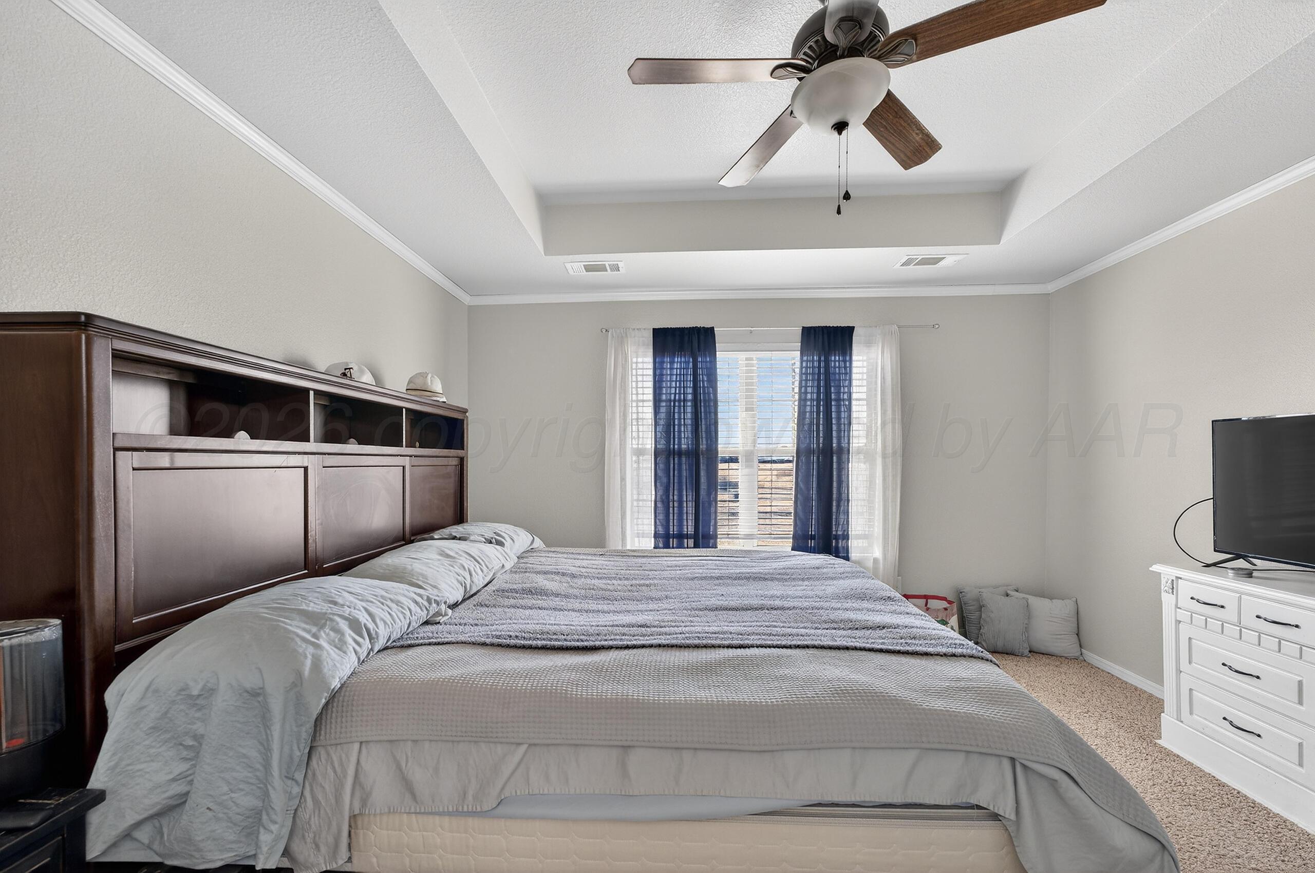 383 County Road 309 Panhandle, TX 79068 - Photo 14 of 35 a bedroom with a bed and a television