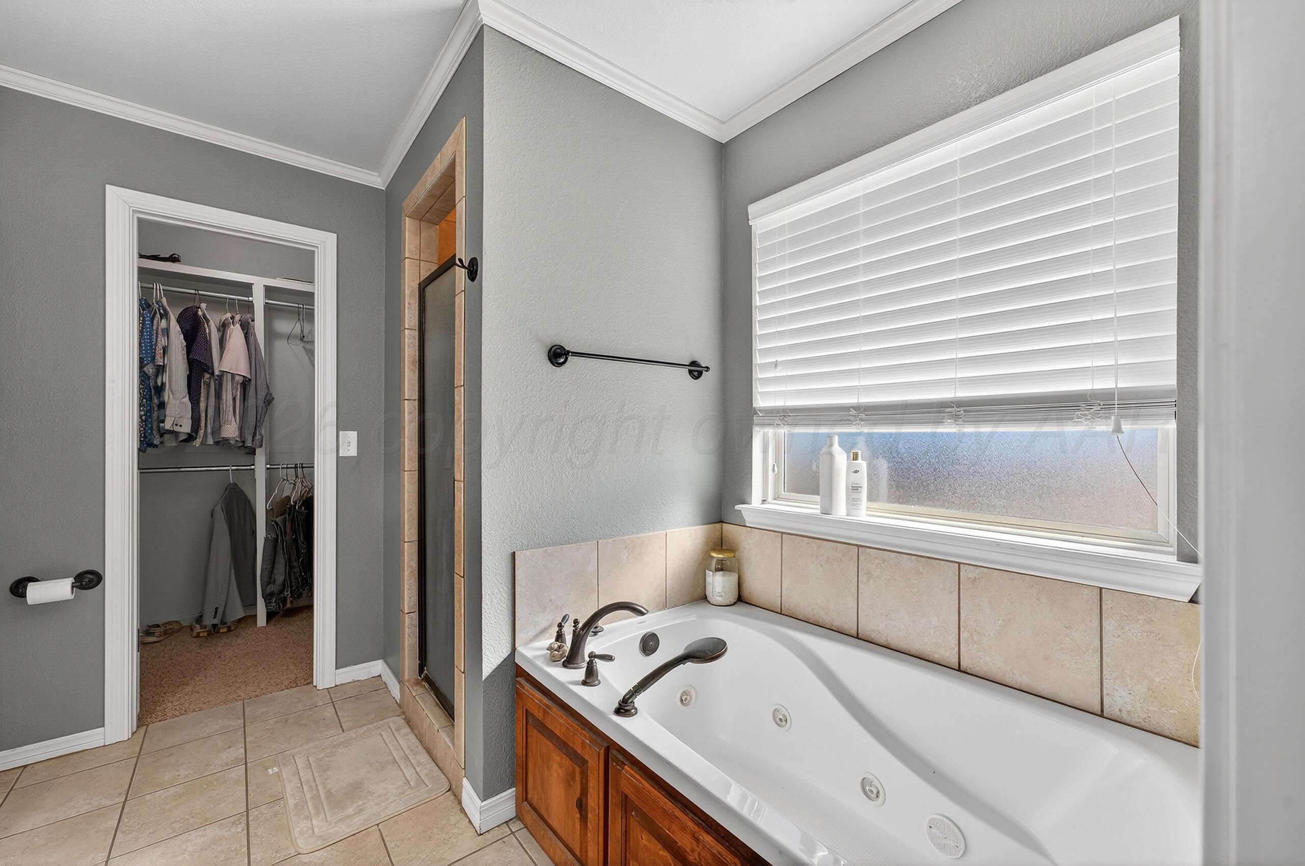 383 County Road 309 Panhandle, TX 79068 - Photo 16 of 35 a bathroom with a bathtub and a sink