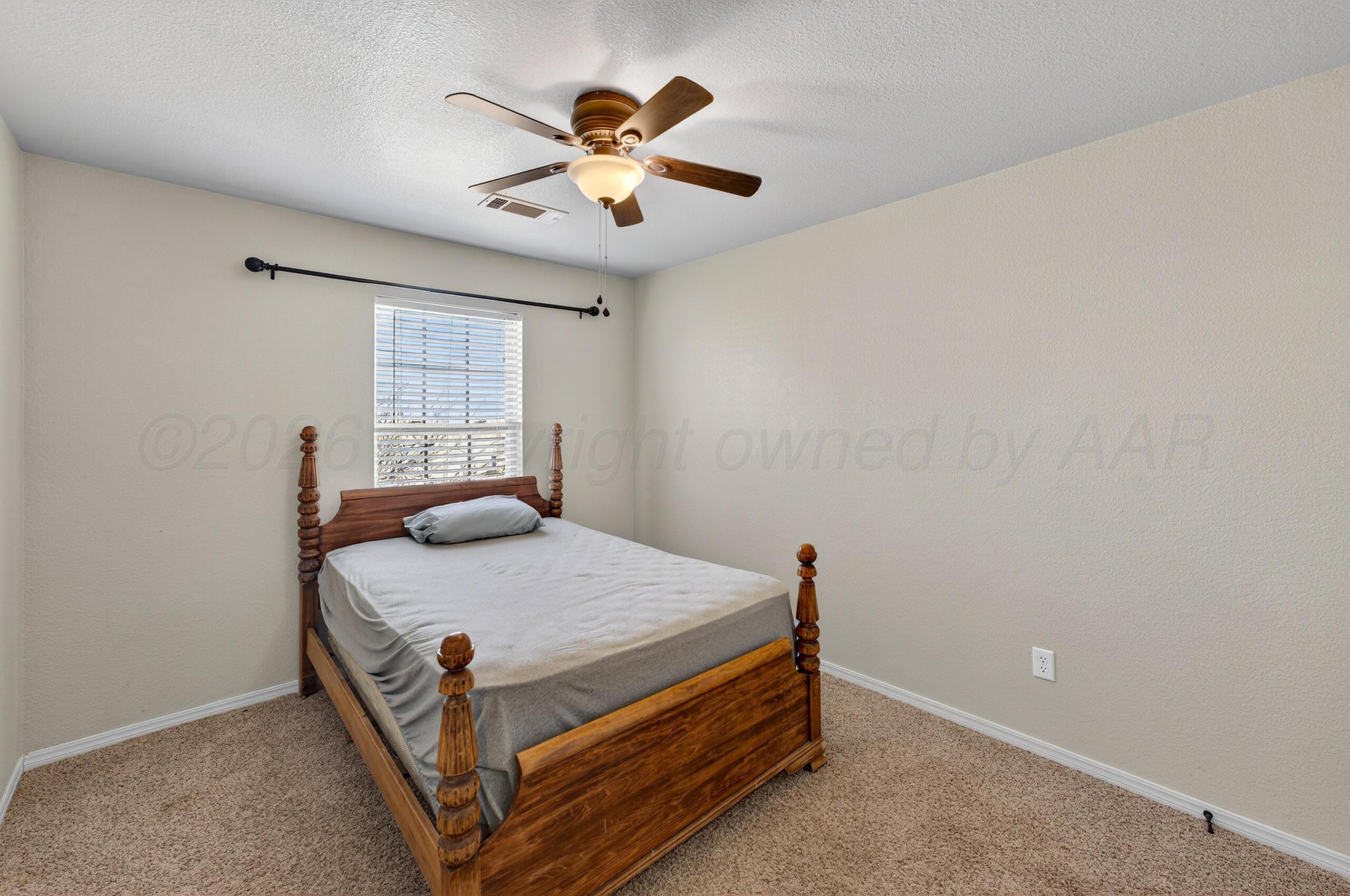 383 County Road 309 Panhandle, TX 79068 - Photo 18 of 35 a bedroom with a bed and window
