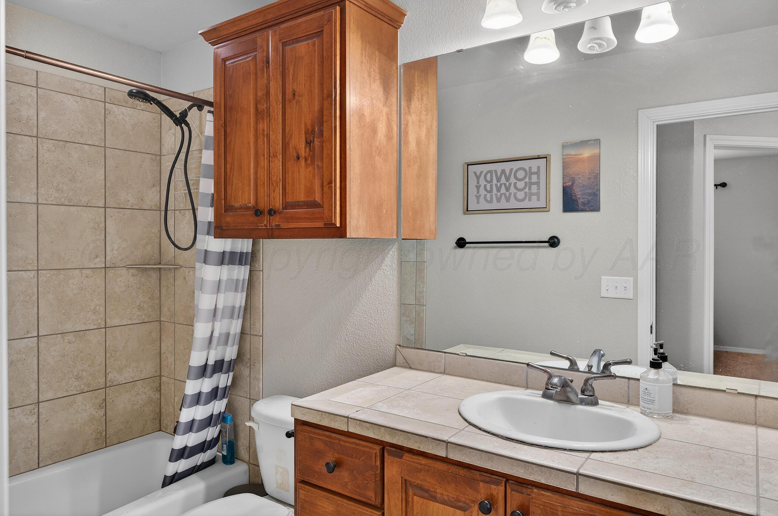 383 County Road 309 Panhandle, TX 79068 - Photo 22 of 35 a bathroom with a sink and a mirror