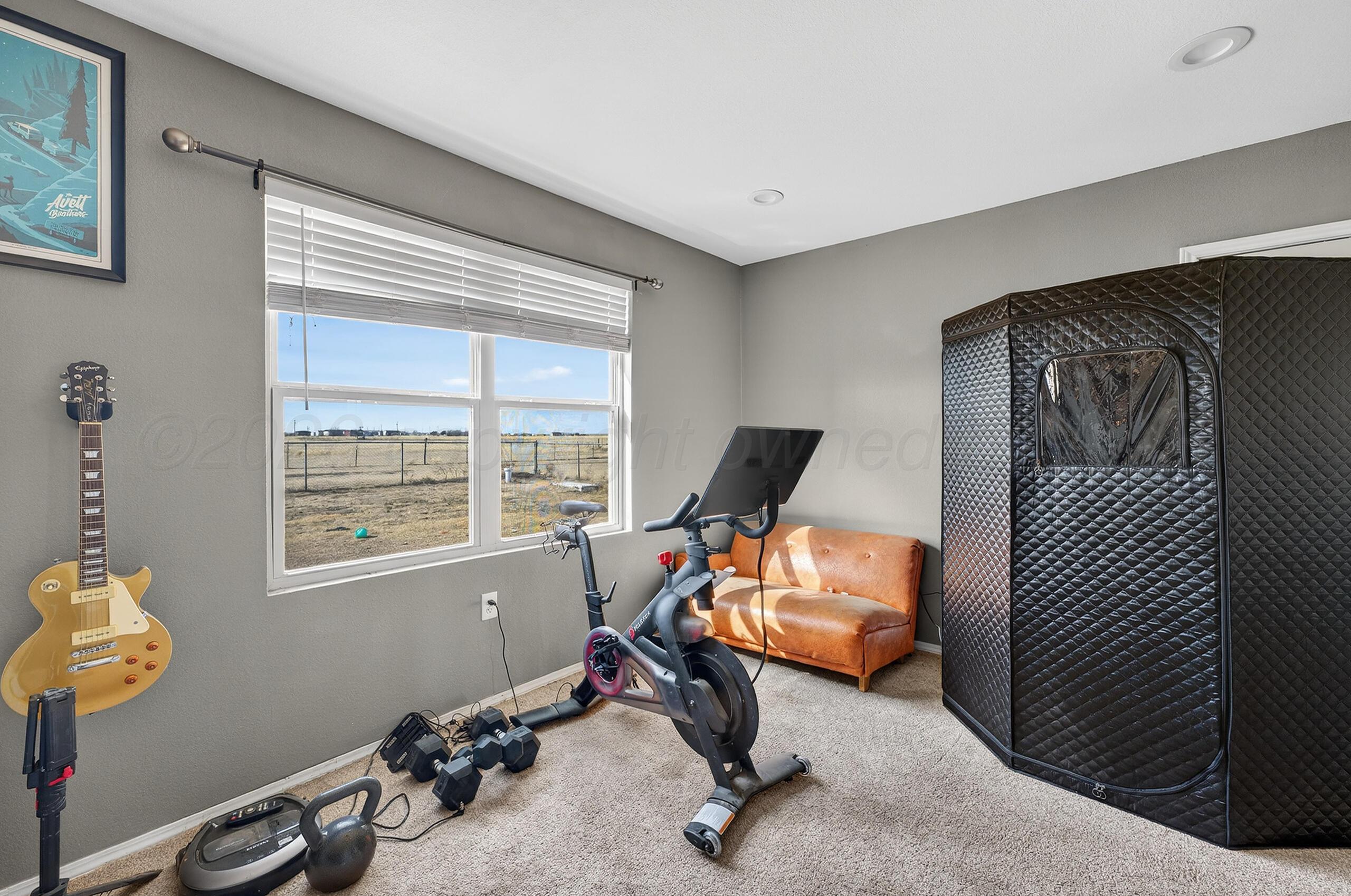 383 County Road 309 Panhandle, TX 79068 - Photo 30 of 35 a view of a workspace with furniture and a window