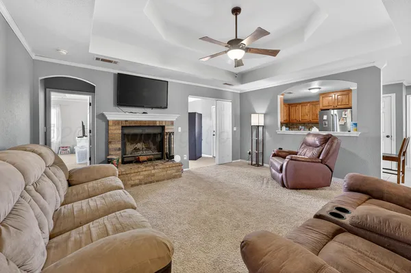 a living room with furniture a flat screen tv and a fireplace