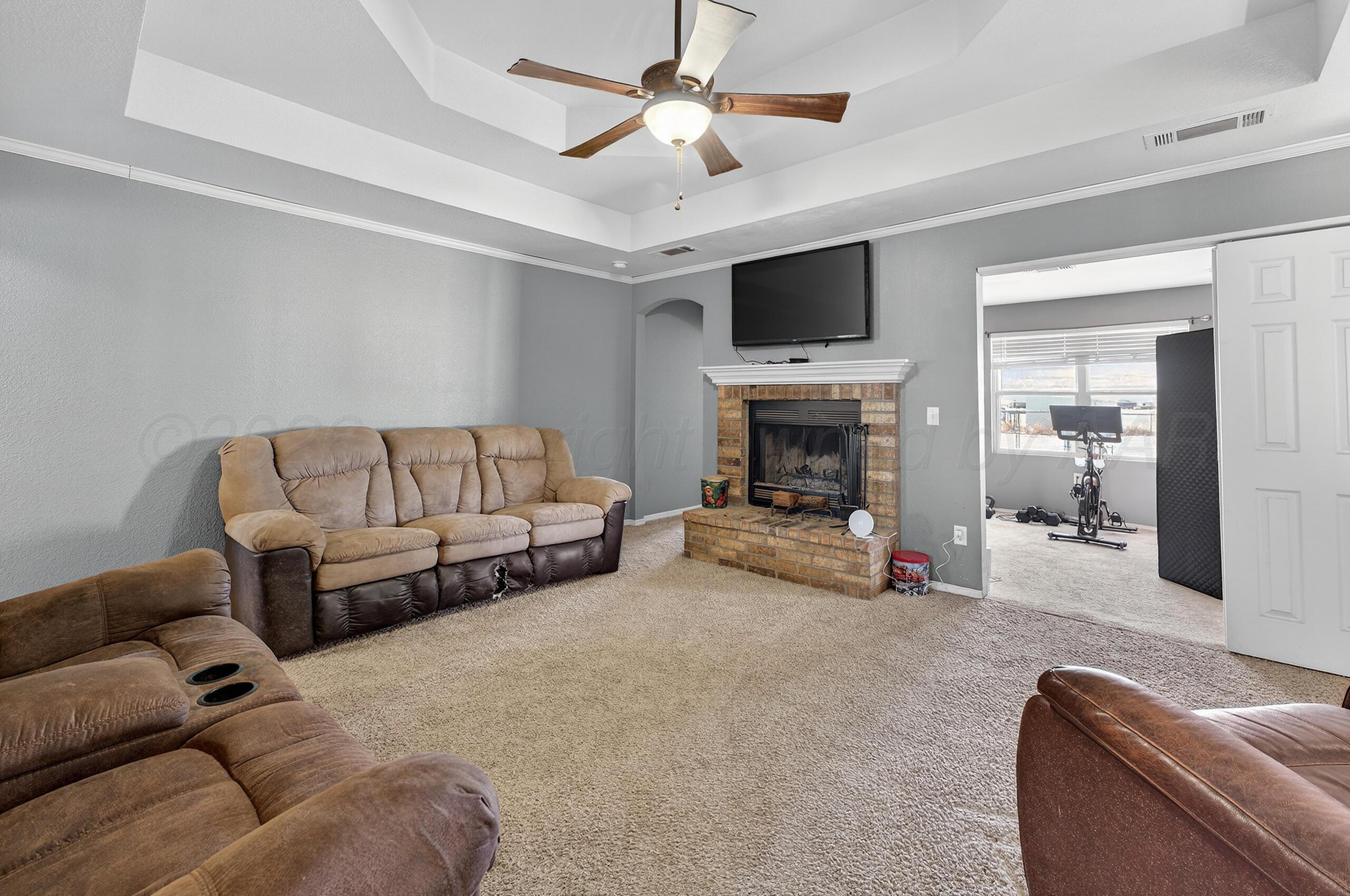 383 County Road 309 Panhandle, TX 79068 - Photo 5 of 35 a living room with furniture and a fireplace