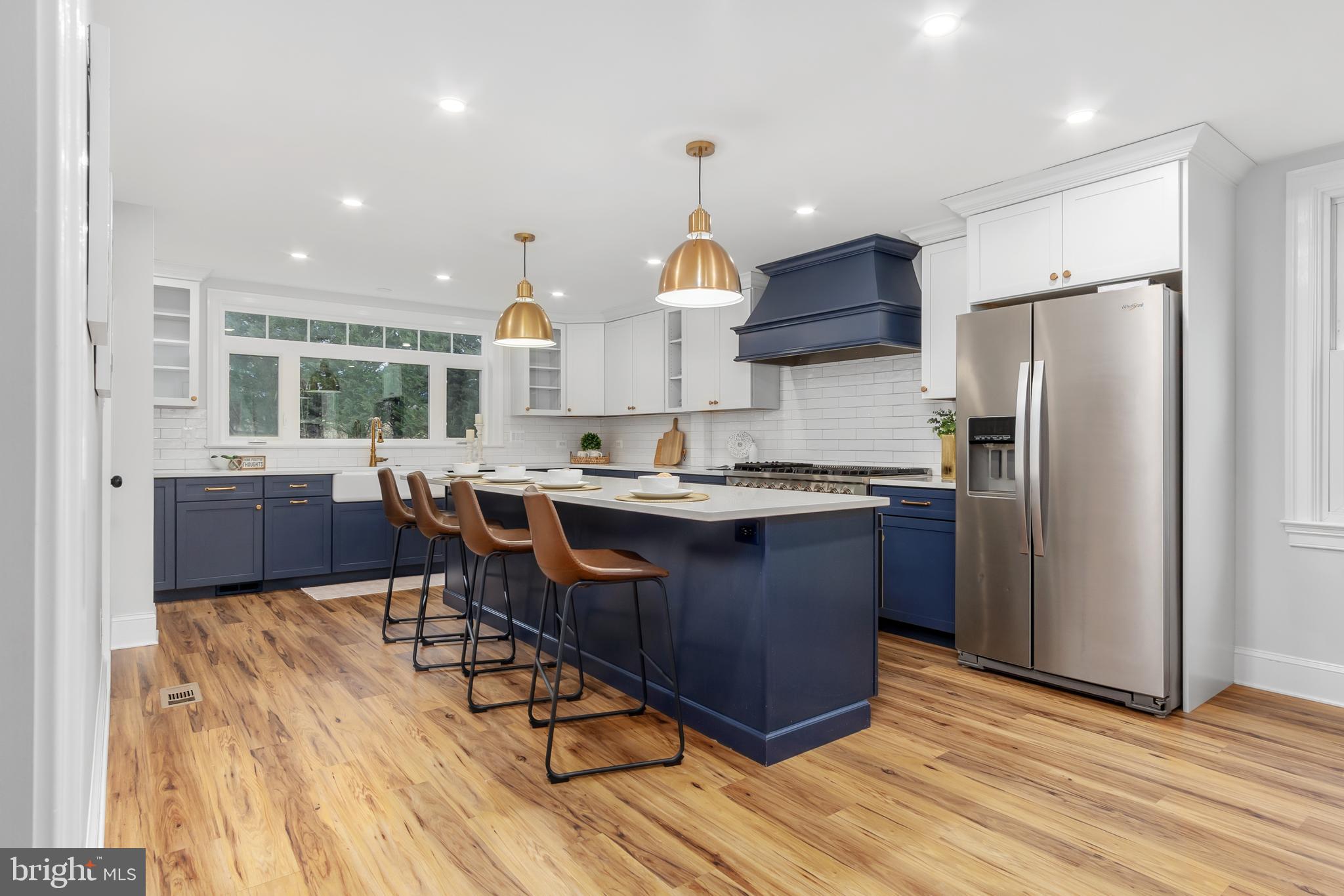 2730 Marker Road Middletown, MD 21769 - Photo 19 of 73 a kitchen with stainless steel appliances granite countertop a refrigerator a sink dishwasher a stove and a dining table with wooden floor