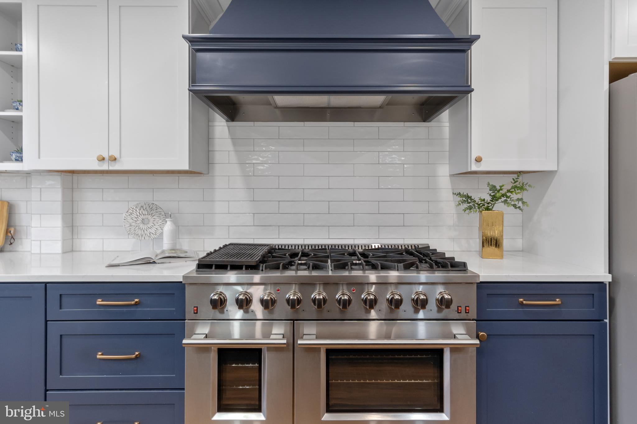 2730 Marker Road Middletown, MD 21769 - Photo 21 of 73 a stove top oven sitting inside of a kitchen and white cabinets