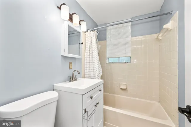 a bathroom with a sink mirror toilet and bathtub