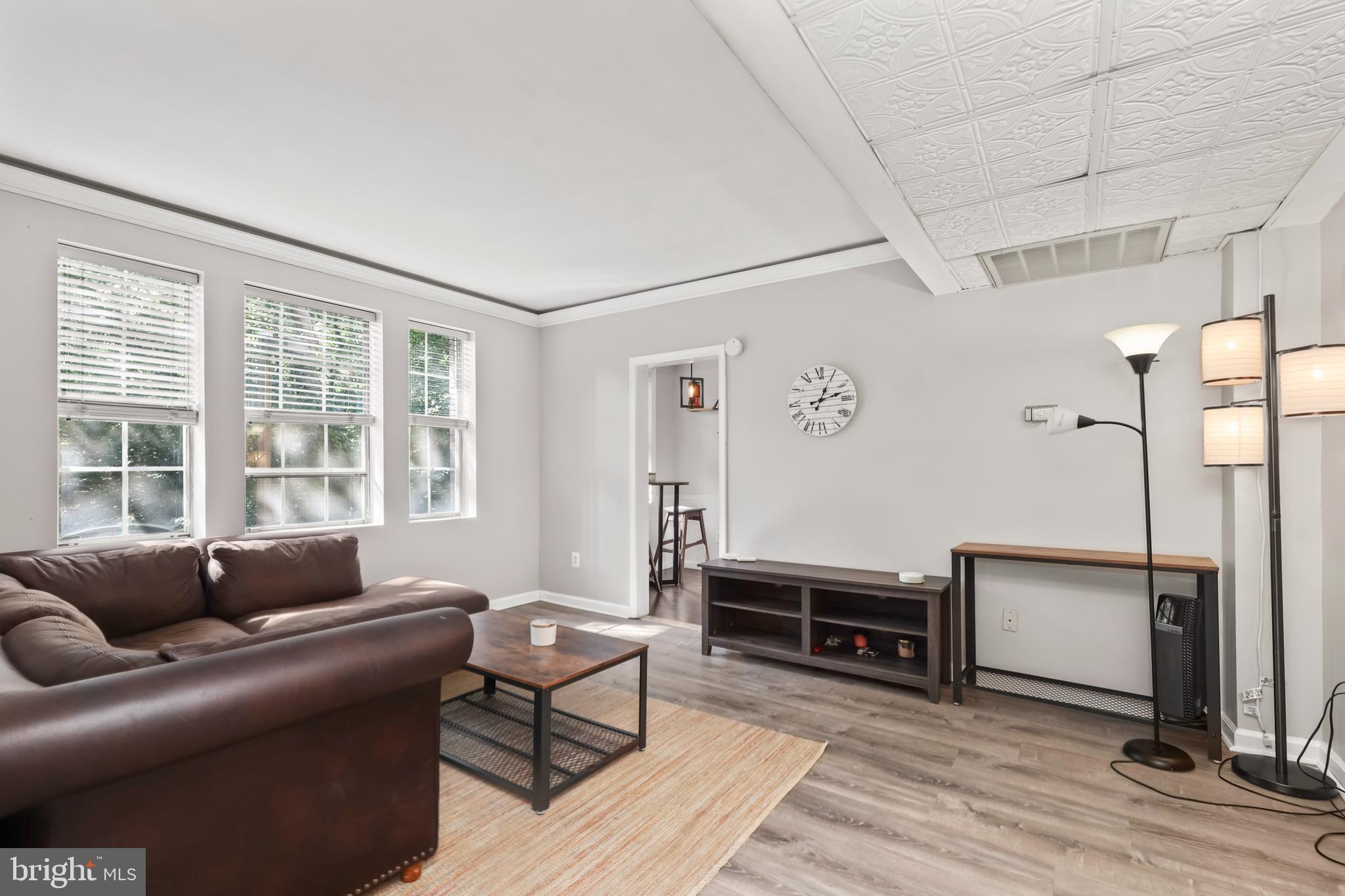 1802 Key Boulevard, Unit 9482 Arlington, VA 22201 - Photo 6 of 28 a living room with furniture a window and wooden floor
