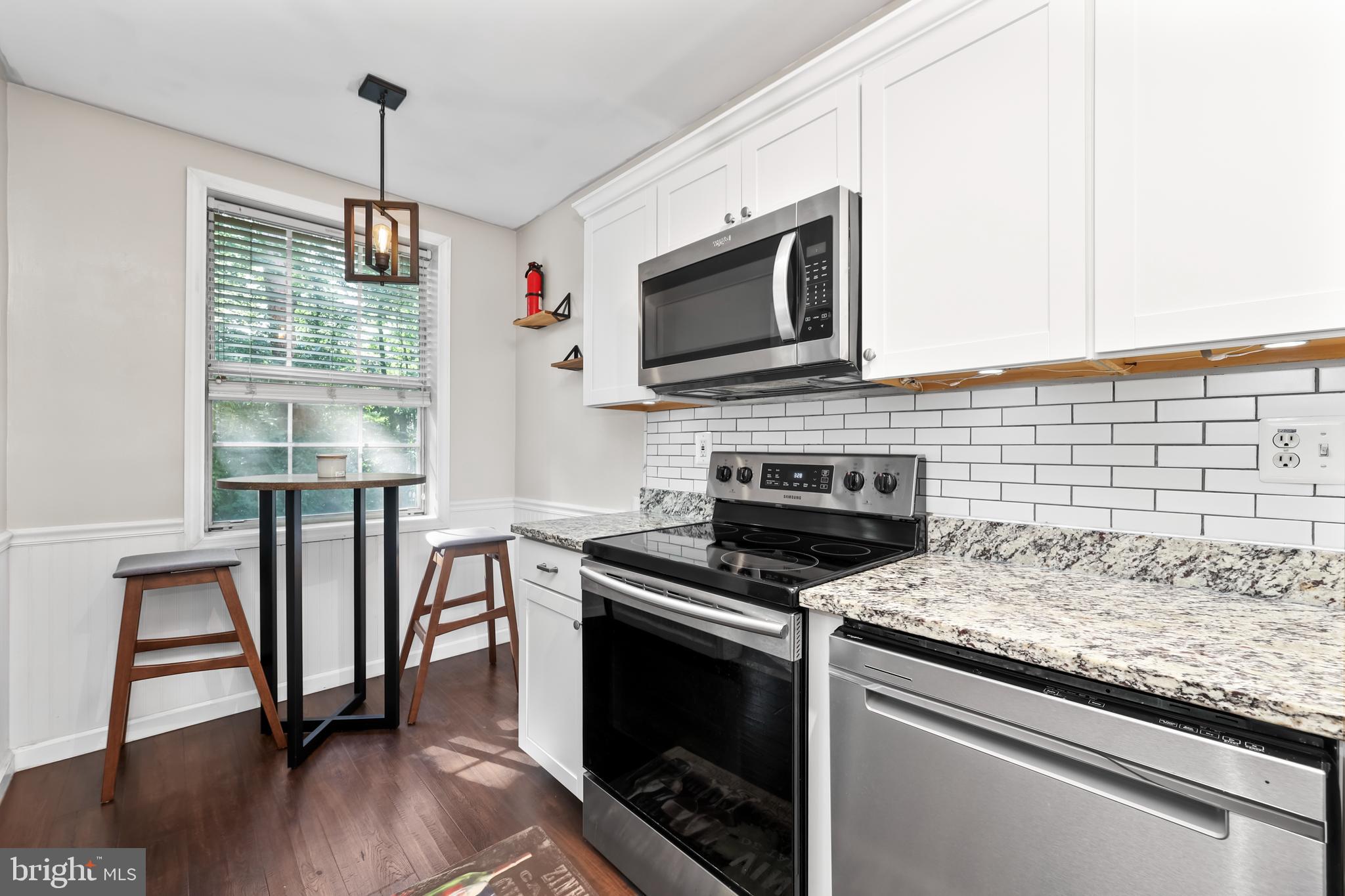 1802 Key Boulevard, Unit 9482 Arlington, VA 22201 - Photo 8 of 28 a kitchen with stainless steel appliances granite countertop a stove and a microwave